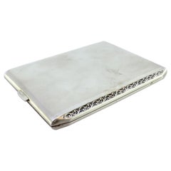 Matte silver cigarette case w/ raised strips along the length
gold interior