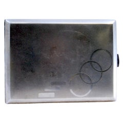 Matte silver cigarette case with geometric figures, gold interior and hinged lid