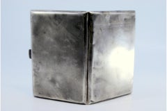 Matte silver cigarette case with geometric lines on the hinged lid