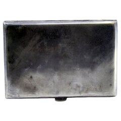 Matte silver cigarette case with geometric lines on the hinged lid