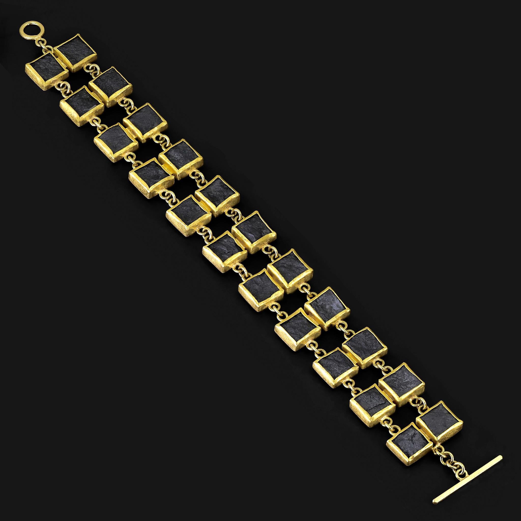 Double Hematite Links Bracelet intricately hand-fabricated by jewelry maker Petra Class featuring twenty-two natural, matte-finished hematite squares individually bezel-set in signature-finished 22k yellow gold in rows of two, and connected by 18k