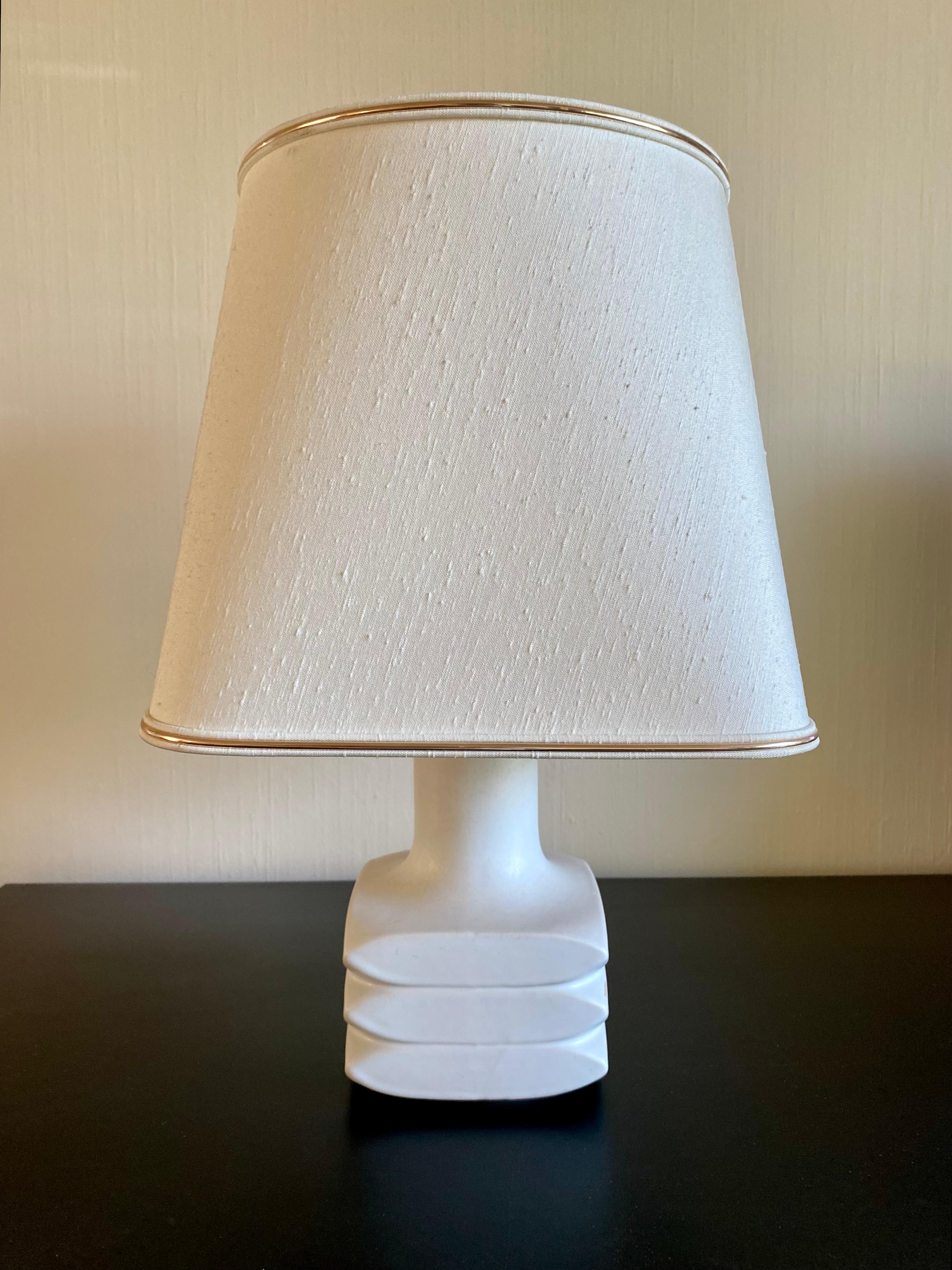 White matte table lamp by Cari Zalloni for Steuler. 
Steuler was founded by Georg Steuler. Most fame was gained by the 'Zyklon', 'Facette', and 'Çontinua' series from designer Cari Zalloni. 
On the bottom we can read a relief print, the word Germany