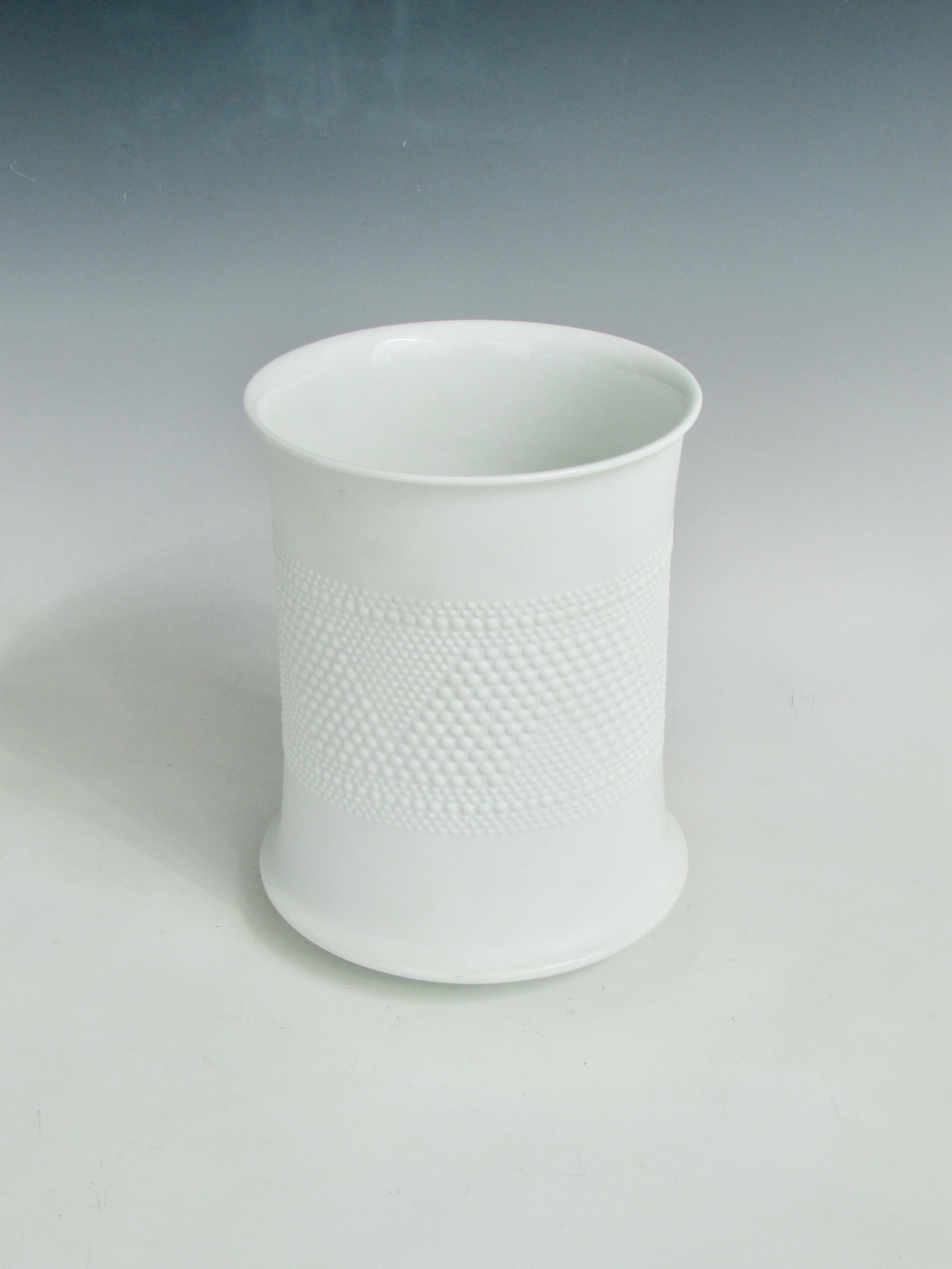 Tall cylinder shaped white porcelain vase with flared opening . Designed 1970 by Tapio Wirkkala for Rosenthal Studio Line . Tactile ‘Drops’ designed on its exterior . Matte finish exterior with gloss glaze interior. Marked underside. Excellent