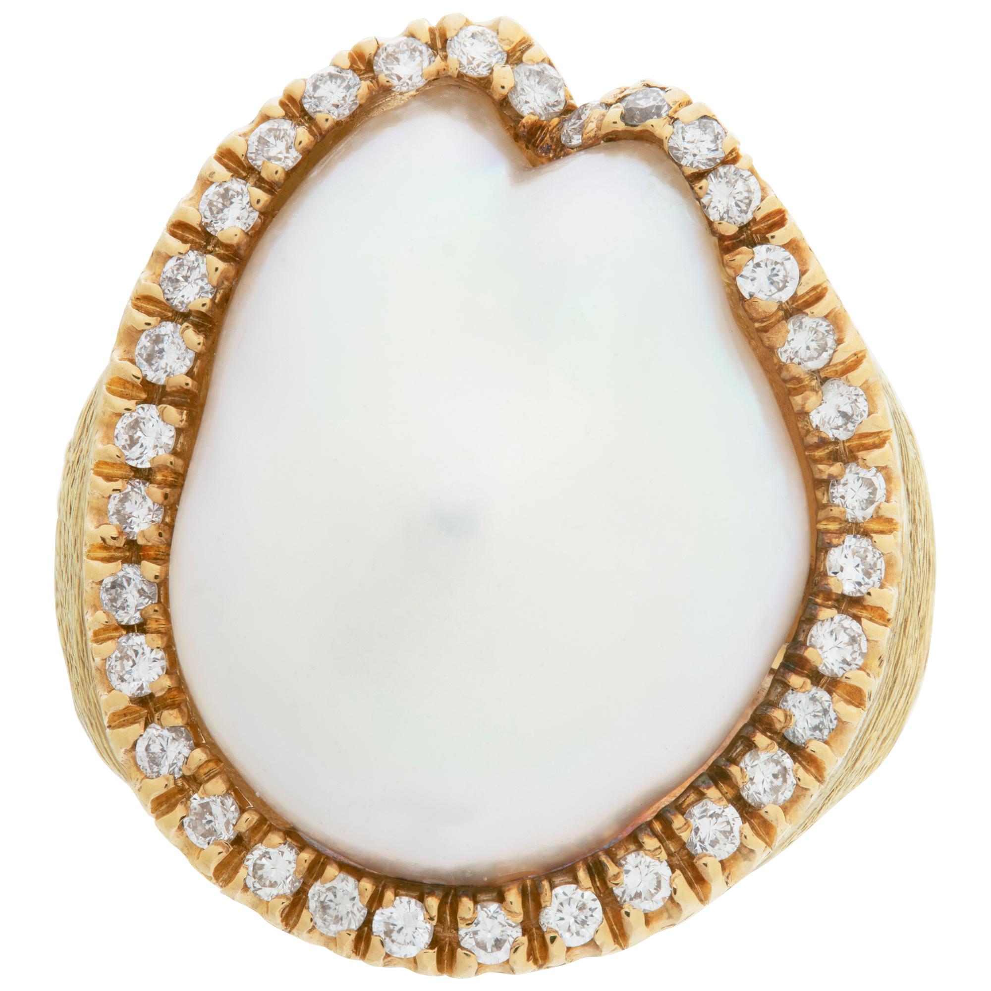 Baroque 17.5 x18mm pearl ring surrounded by 0.50 carat in diamonds in 18k matte yellow gold. Size 5.5, measures 21mm at head, 3.5mm at shank.This Pearl/diamond ring is currently size 5.5 and some items can be sized up or down, please ask! It weighs