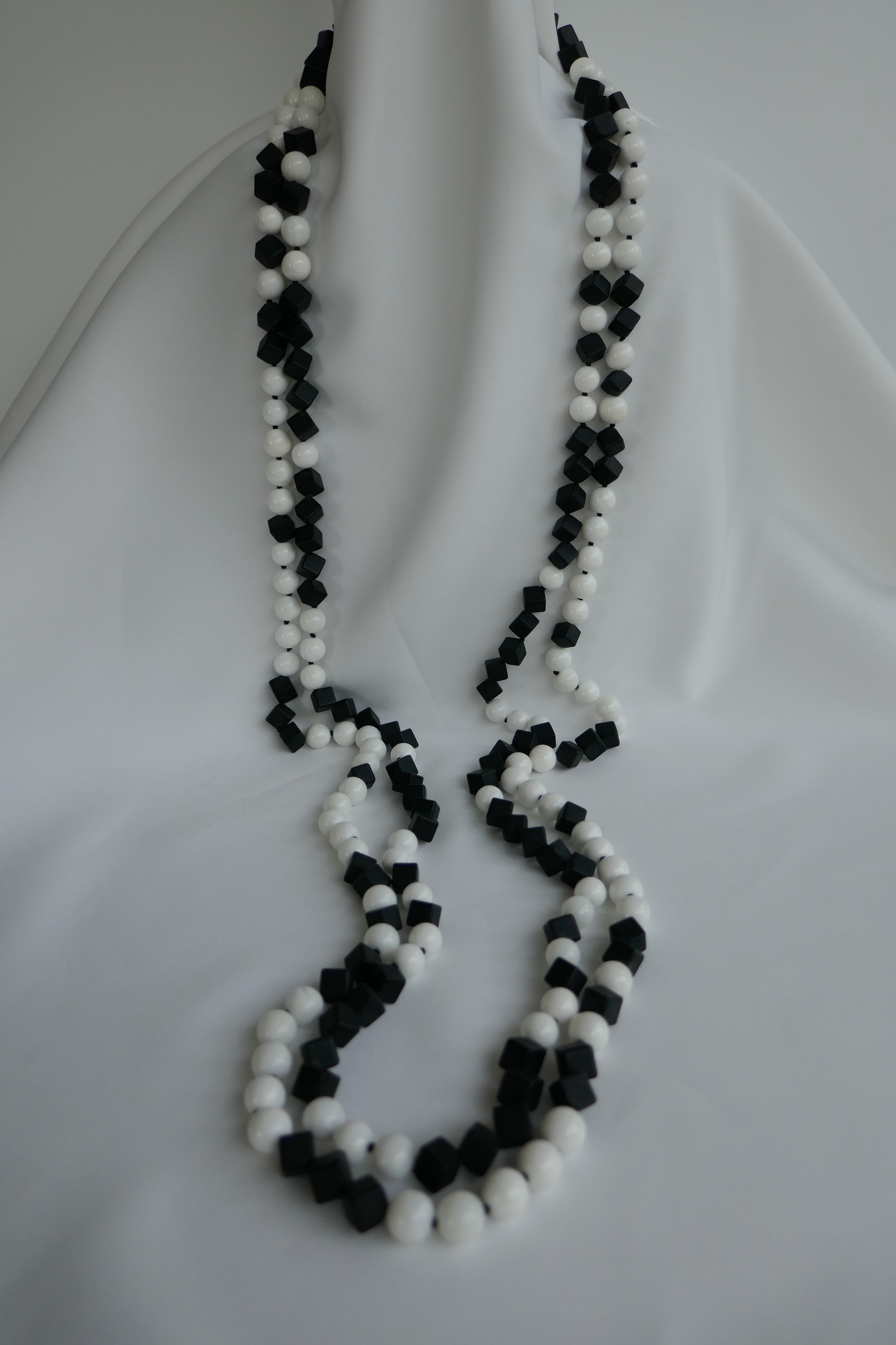 This necklace what I call a gin gang necklace. Where I have the white beads on one necklace the other has matted onyx in the same place. The matted onyx cubes are 8mm and the white shell are 10mm. This necklace is very versatile. I may be worn long,