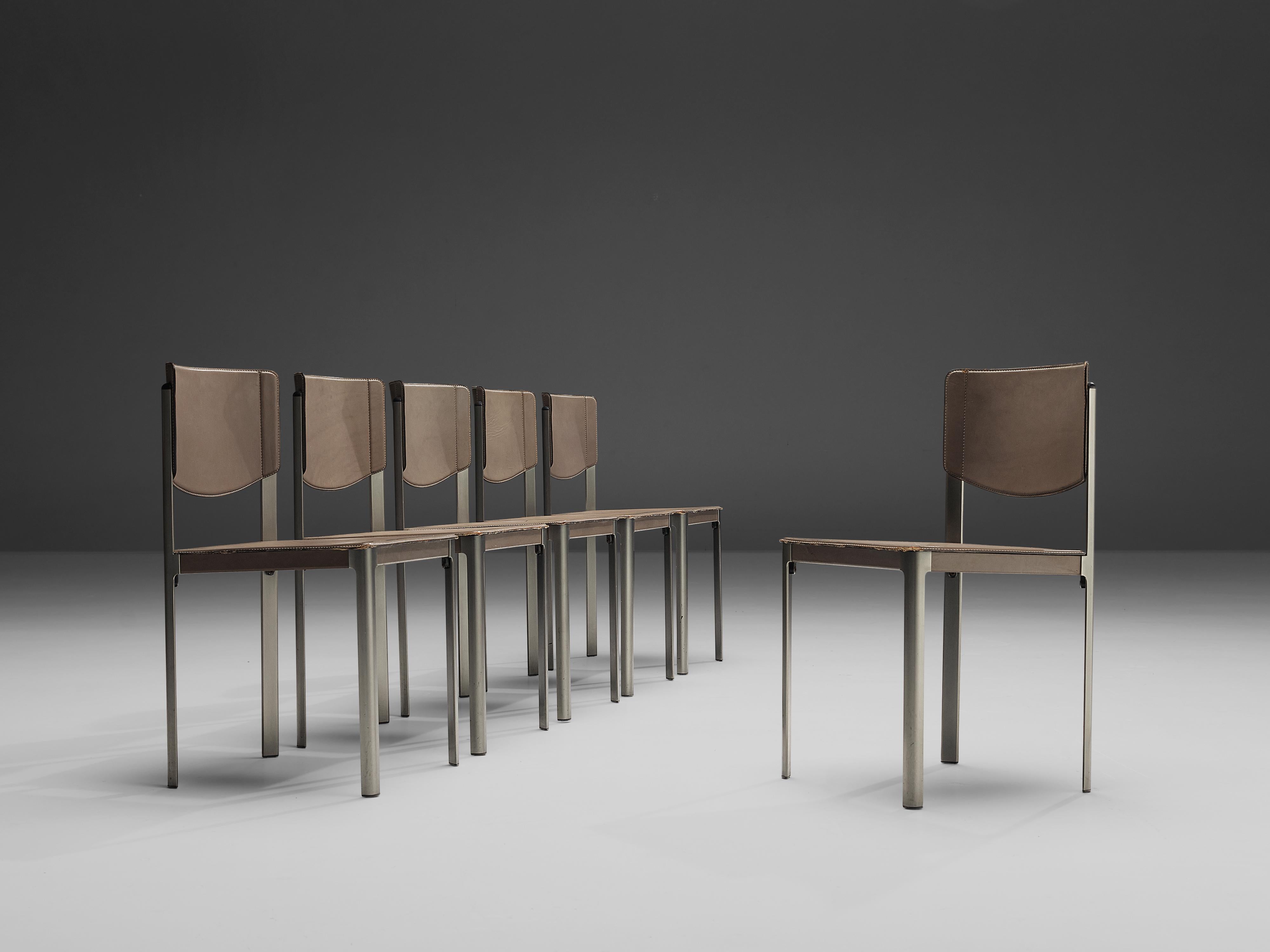 Matteo Grassi, set of six dining chairs, leather and steel, Italy, 1980s.

These sophisticated grey leather chairs by Matteo Grassi, feature an angular design. The seat and base are upholstered in leather, leaving the metal frame bare. The leather