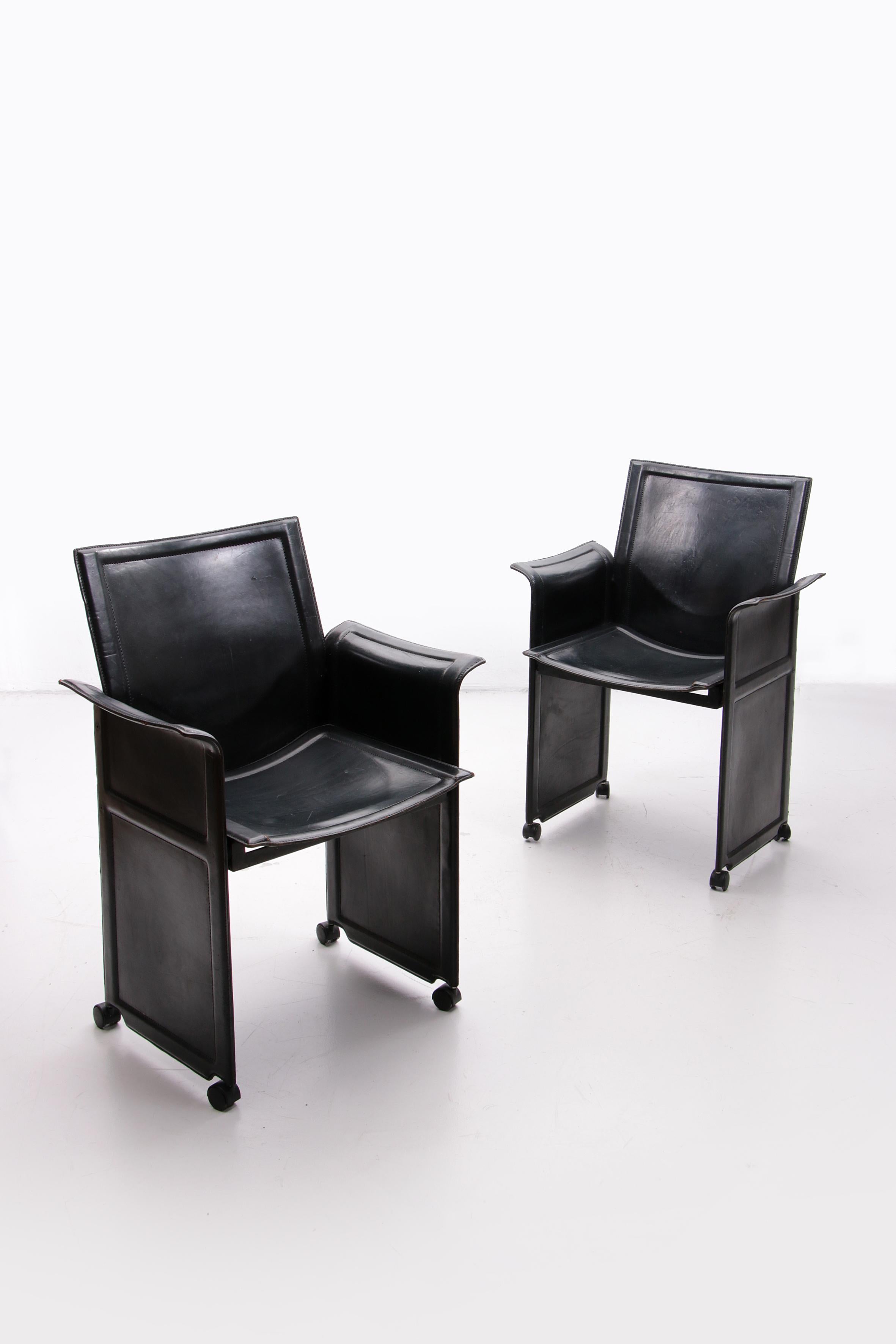 Rare dining room chairs.

The used Matteo Grassi Korium has a special appearance. The frame of the chair is fully covered with sturdy black leather. The leather is stitched and molded over metal frame panels, a type of architectural design used by