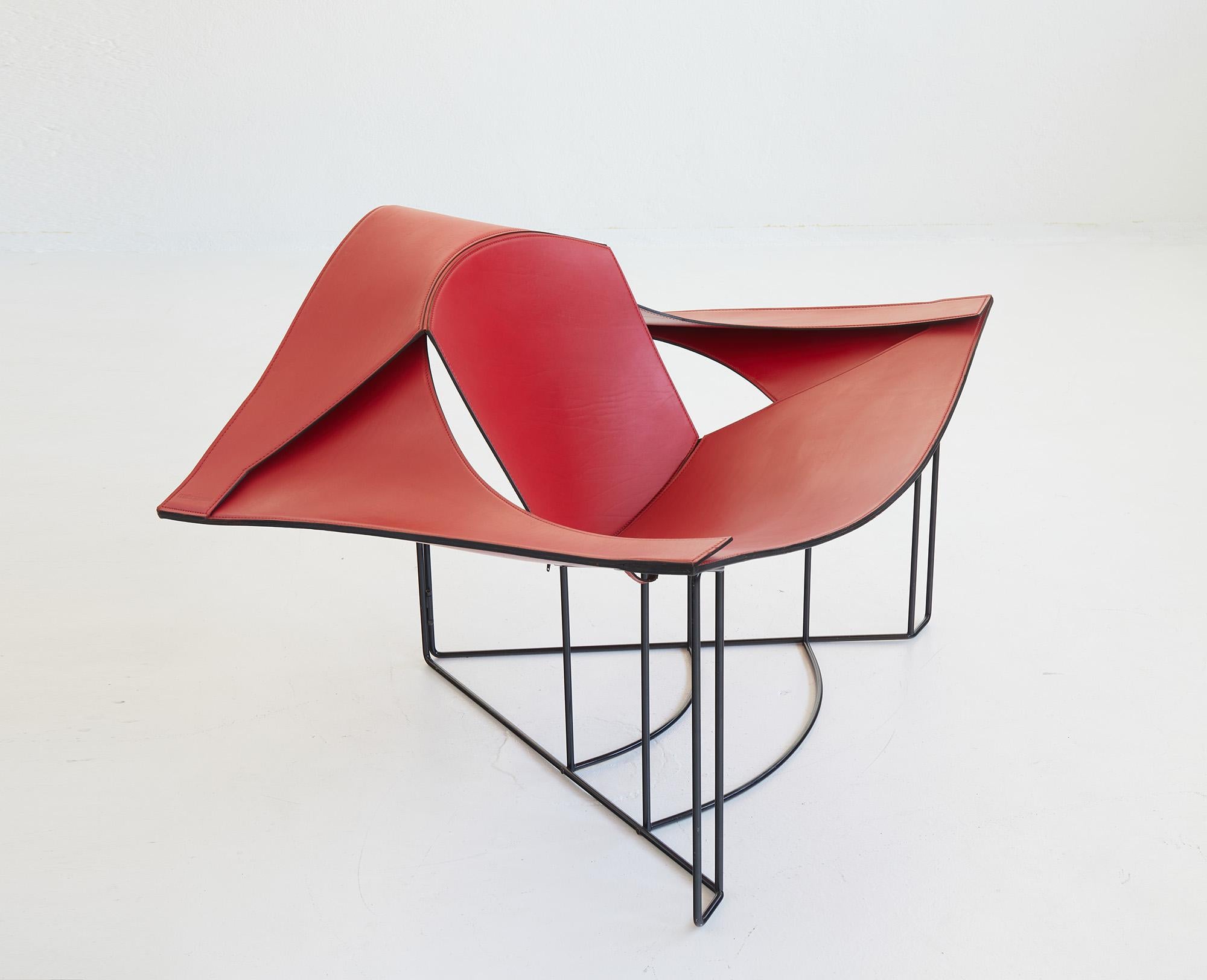 Sculptural lounge chair designed by Jacques Harold Pollard for Matteo Grassi Italy in 1987. 

The chair features hand-stitched dark red leather panels that seamlessly blend with its architectural framework. The chair's frame crafted from