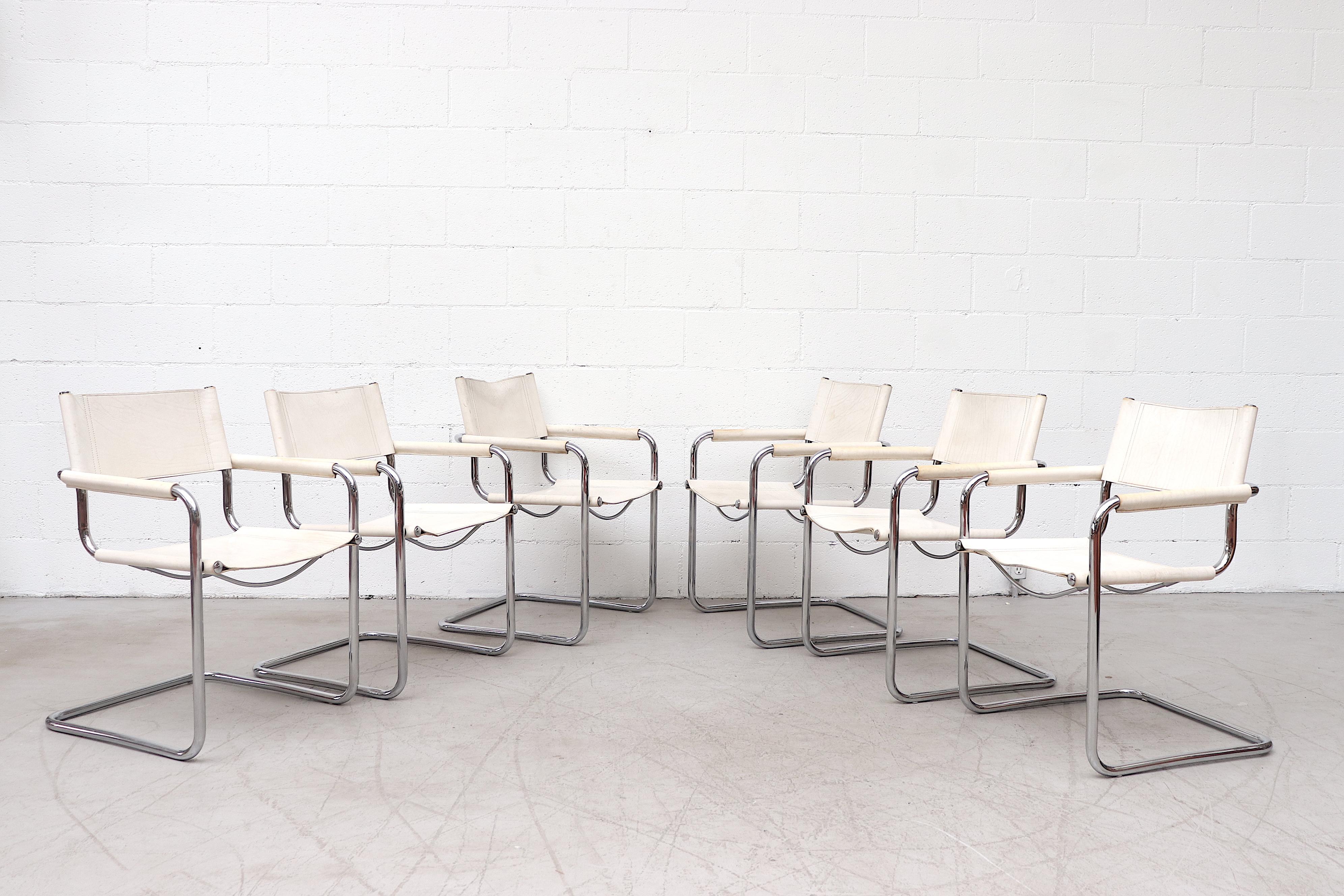 Gorgeous white leather Matteo Grassi style cantilevered armchairs with tubular chrome frame and leather wrapped arm rests. In original condition with visible wear and scratching. Some staining and color variations. Set price.