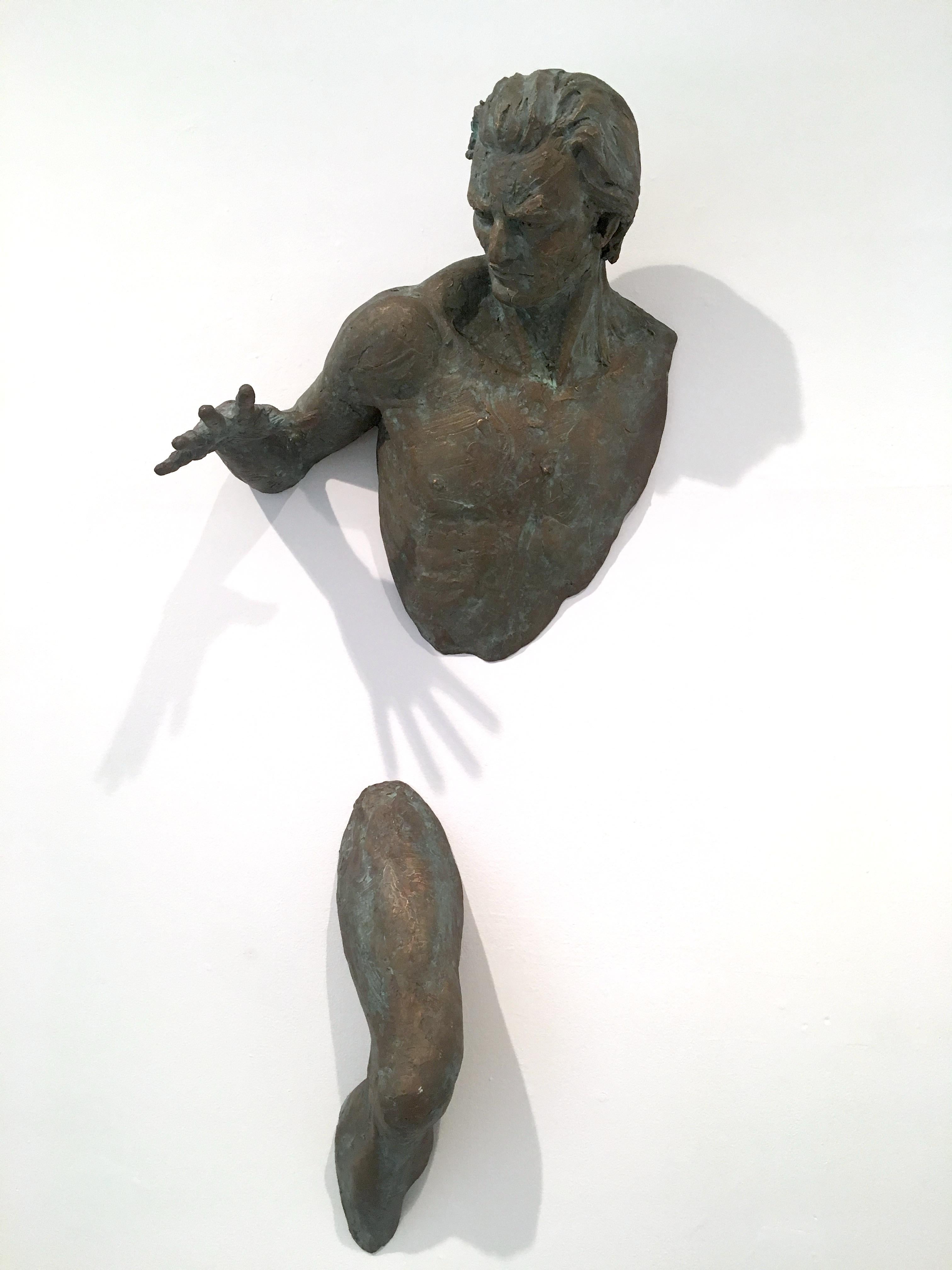 This work consists of two bronze pieces; the upper torso and a leg. Reaching out intensely, the upper body hovers on the wall above the upper thigh, creating the illusion that the sculpture is emerging from the wall.  This work is from the Extra