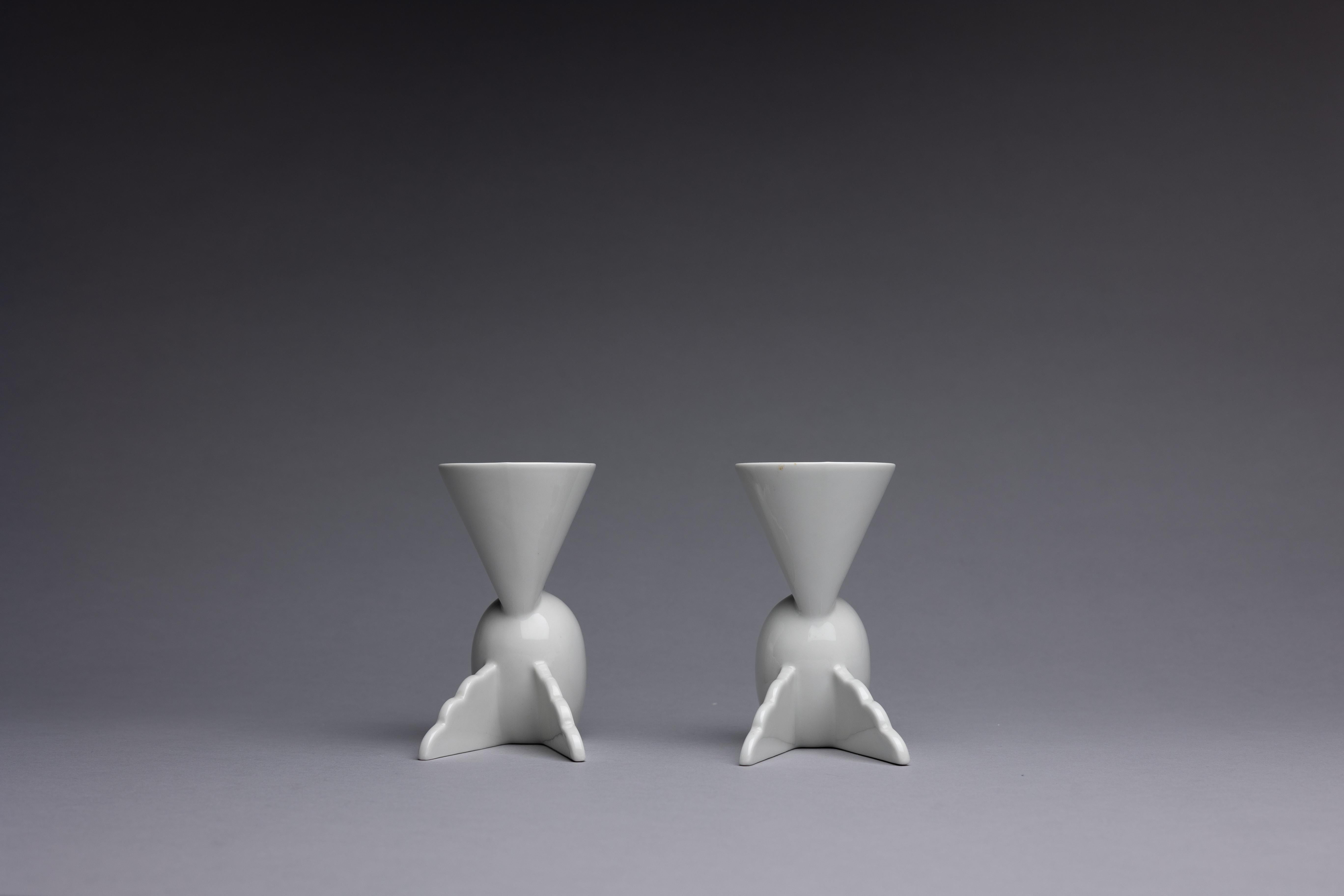 A pair of white porcelain 'Onega' cocktail cups, designed by Matteo Thun in 1982 for the Memphis group.

Memphis Milano formed in the 1980s as a response to the rather formulaic design principles of the Mid-Century Modern style. The group’s