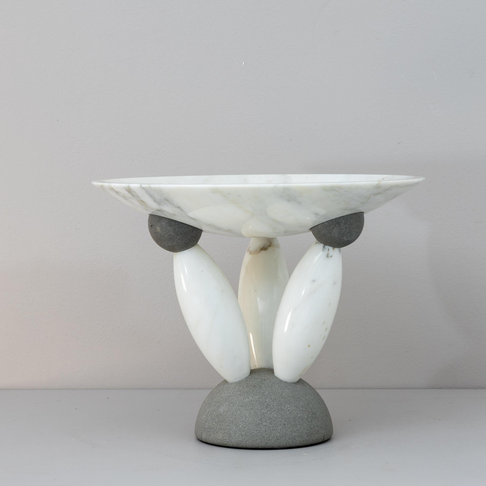 Matteo Thun Modernist marble centerpiece.
a shallow bowl in white marble atop a sculptural,
minimalist base of Pietra Serena and three marble supports.