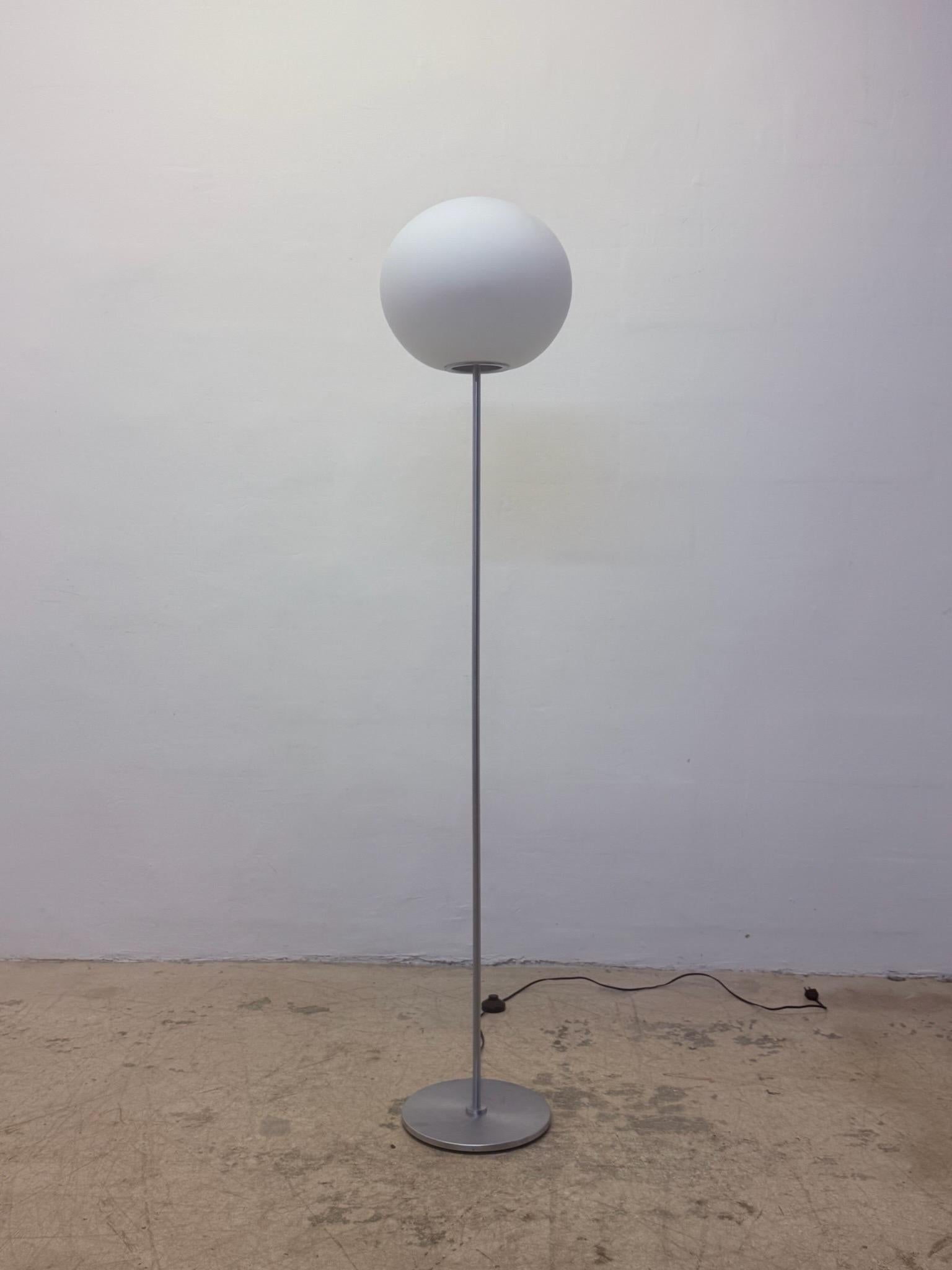 From the Sphera lighting collection, this Sphere F series floor lamp consists of a satin white blown glass diffuser on a steel base stem and base designed by Matte Thun and produced by Leucos.  Has a foot on/off switch and maintains label underneath.