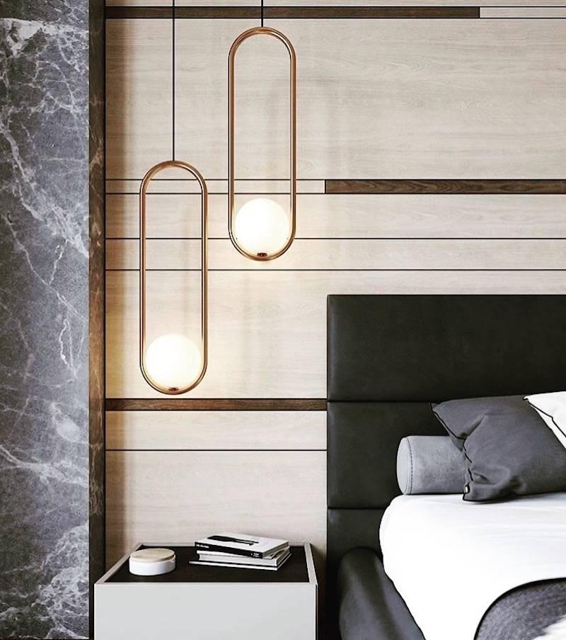 A labour of love, Mila 7 chandelier or pendant was realized through the marriage of handblown glass and the soft geometry of bent metal form. The glow of a pearl-like sphere is coddled in perfect harmony within a elongated loop, resulting in a