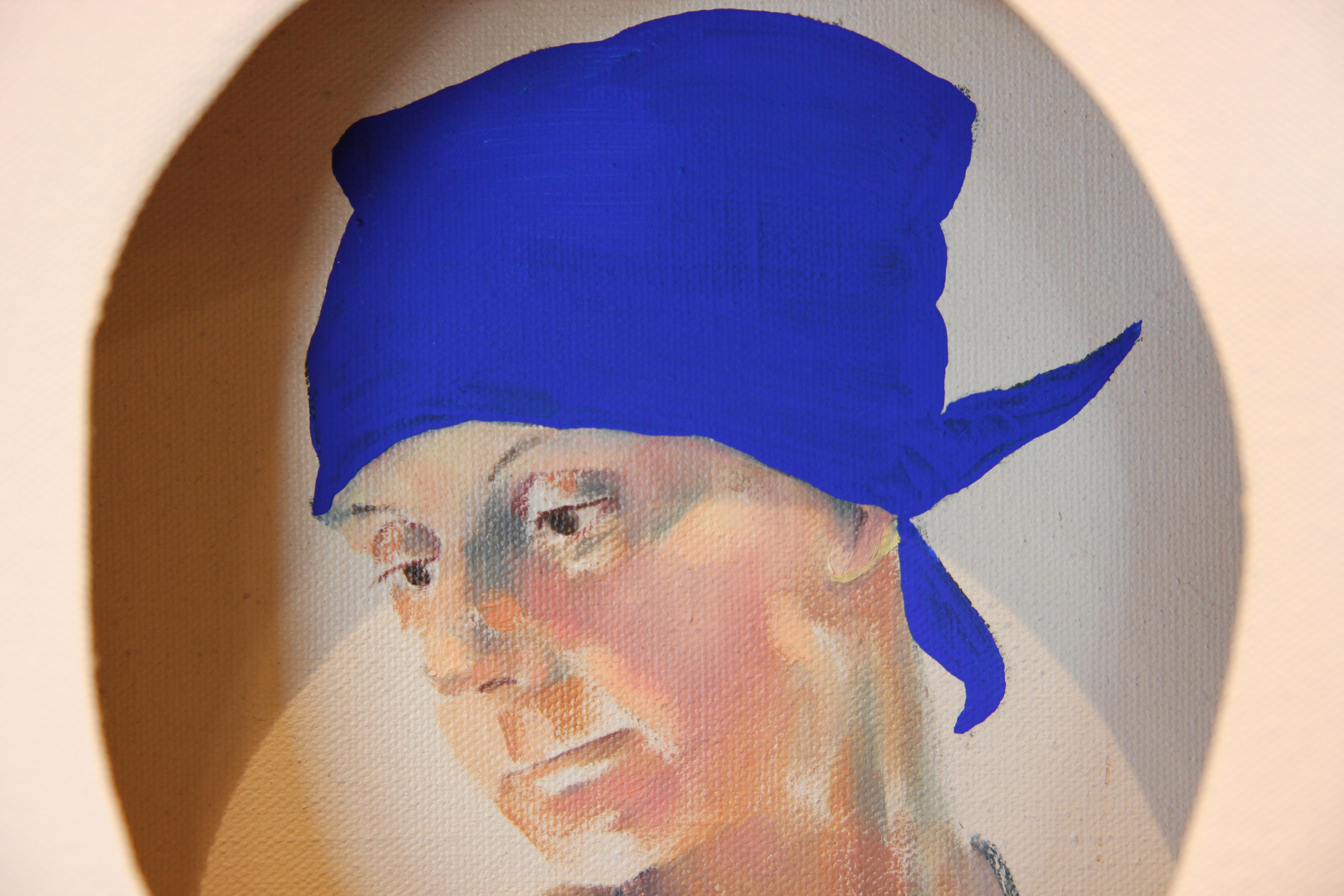Three dimensional conceptual painting by Matthew Reeves. White painted canvas stretched over a framed painting of a woman with bright blue handkerchief. The artist Matthew Reeves, owner of Reeves Design + Art, painted the canvas with white and