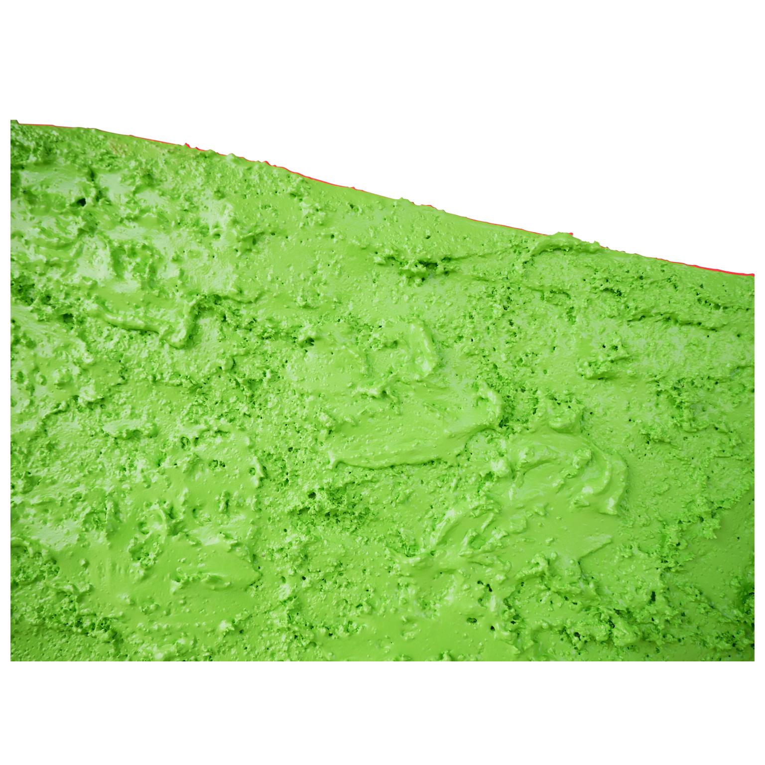 Abstract textured biomorphic shape painted with bright green pigment by contemporary Houston, TX artist Matthew Reeves. The work is designed to hang away from the wall and cast a shadow around the piece. The dynamic texture combined with the