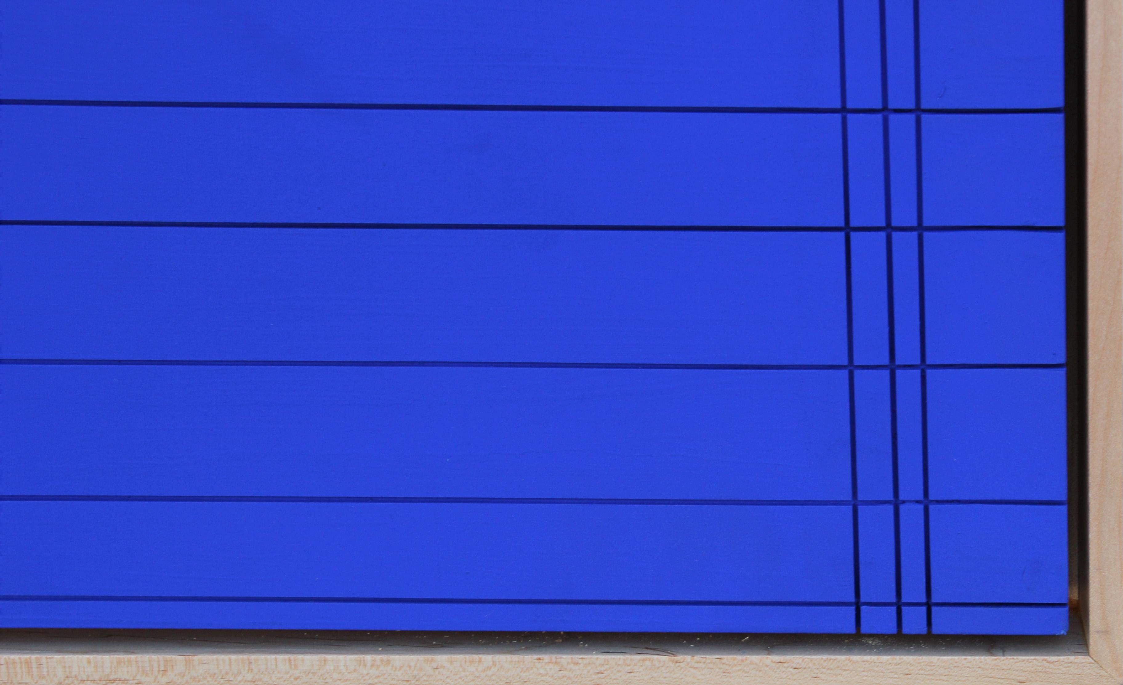 Abstract wall sculpture painting featuring intersecting linear and circular grooves painted with Yves Klein blue paint. The uniqueness of 