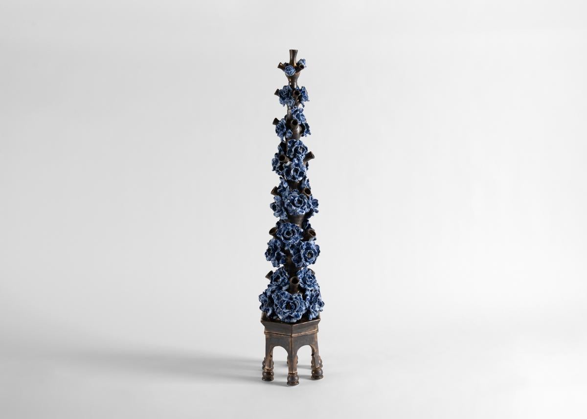 Using fine ceramics fired in a variety of glazes (all of which he crafts himself) Matthew Solomon creates sculptures of beauty, with an element of the unexpected. Repetition of form and color creates order within the chaotic floral