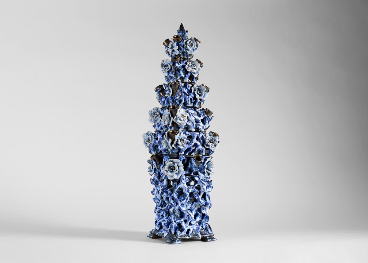 Using fine ceramics fired in a variety of glazes (all of which he crafts himself) Matthew Solomon creates sculptures of beauty, with an element of the unexpected. Repetition of form and color creates order within the chaotic floral camouflage.
 
