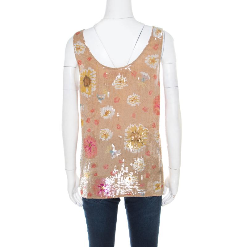 Shimmering and worth flaunting, this tank top from Matthew Williamson is sure to make a great addition to your closet. It is made of 100% silk and features a floral sequin embellished pattern all over. This beige creation can be paired well with