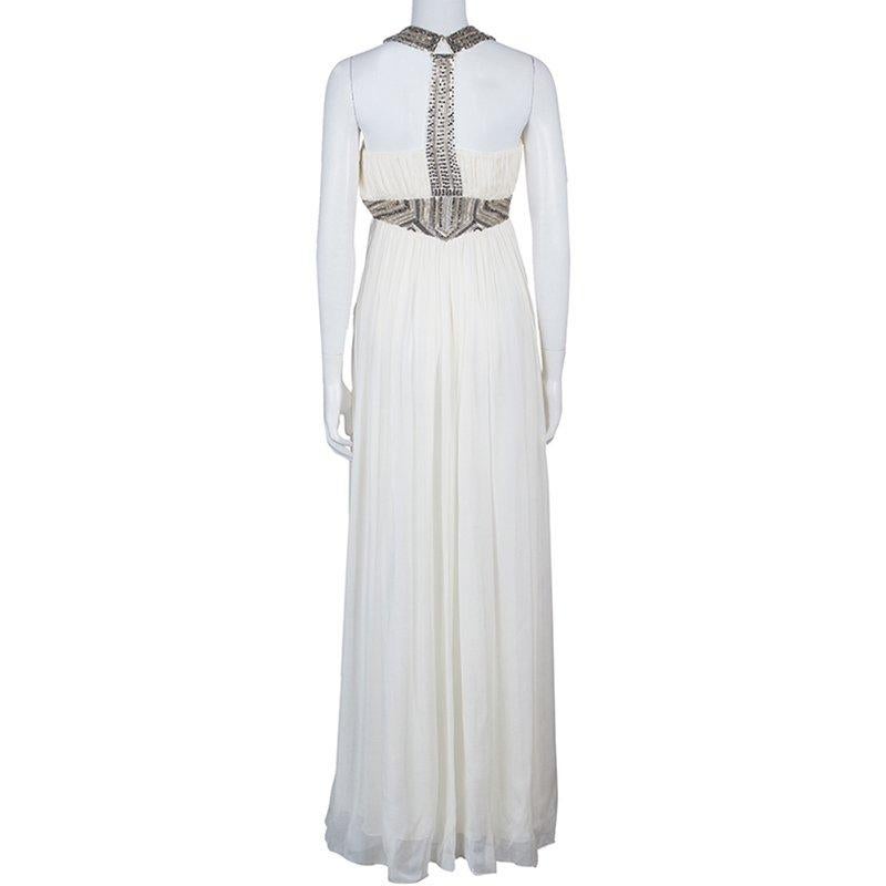 Made in beautiful silk, this Matthew Williamson gown will transform your look. The cream color gives this dress a soft feel, made bold by the embellishments at the waist and the neckline. It has a deep V neck, with pleats at the waist to define your