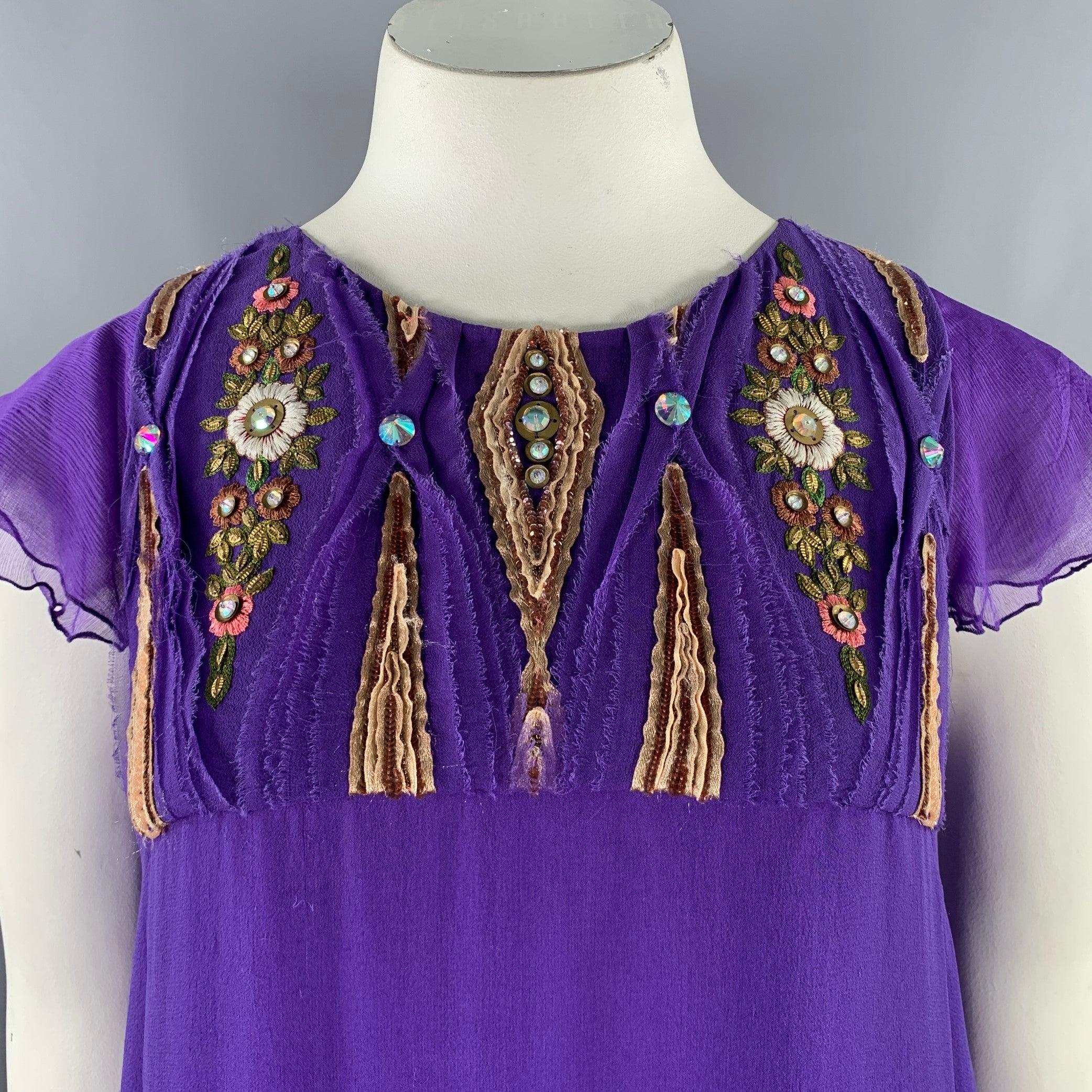 MATTHEW WILLIAMSON dress
in a purple and gold silk fabric featuring ruffled sleeves, beaded and embroidered floral design, and back single button closure. Very Good Pre-Owned Condition. Some snagging, as is. 

Marked:   10 

Measurements: 
