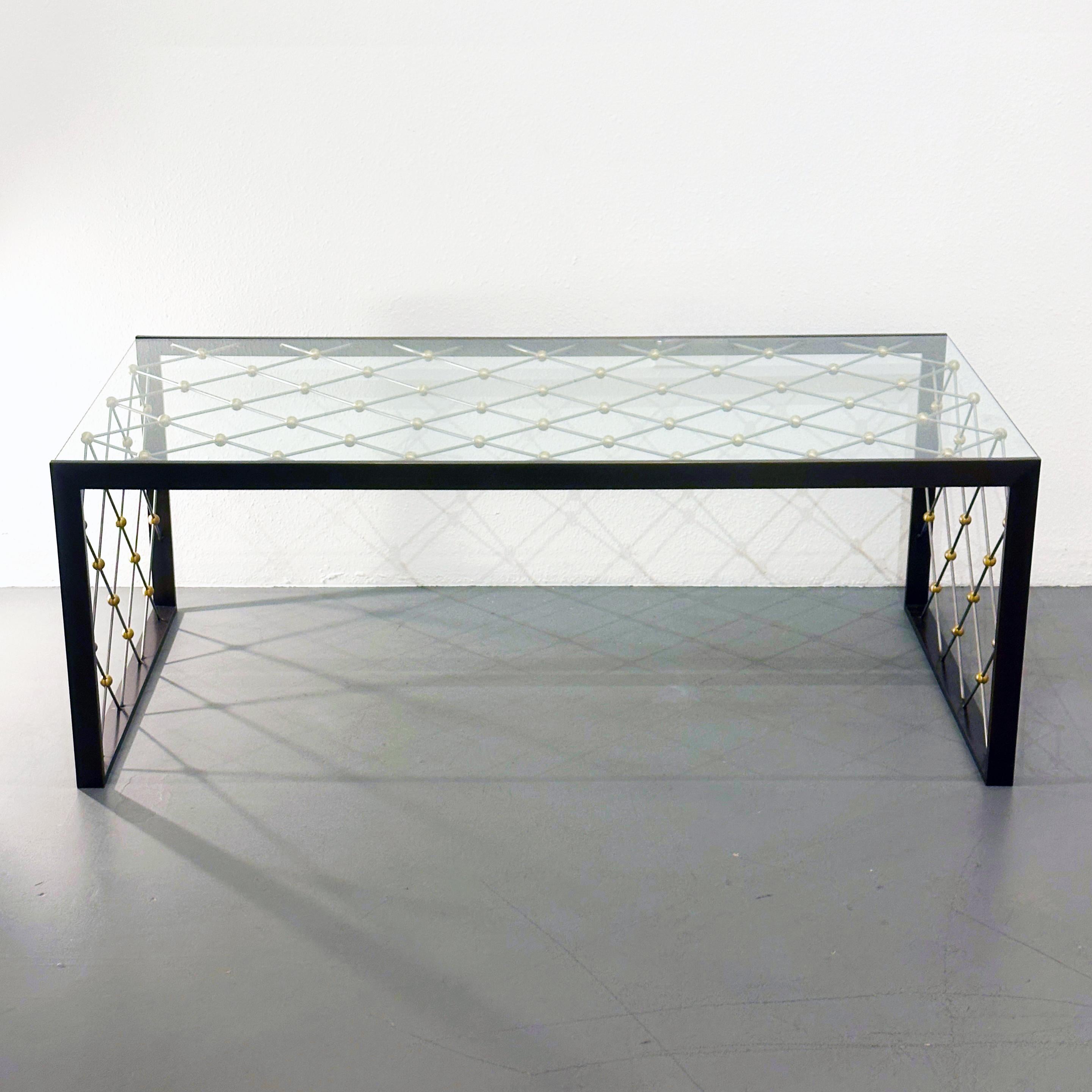 Matthews and Parker Custom Tour Eiffel Table After Jean Royère, ca 2005

This beautiful cocktail / coffee table is a classic modern design custom made in a size requested by the previous owner. It has a bronze frame with a brushed brass and