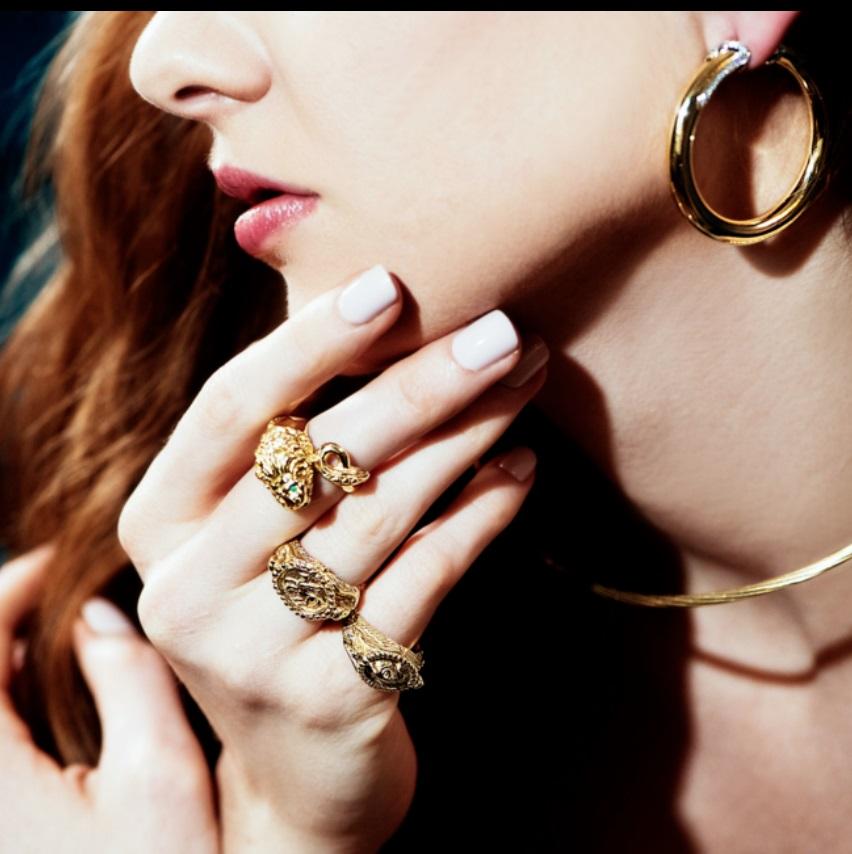 Matthia's & Clare's Three Dimensional Lion Wraps Around Your Finger In 18k Solid Yellow Gold. 

Our lion ring features two emerald set eyes and a ruby in its mouth, and its tail wraps around your finger. The Etruscans are recognized around the world