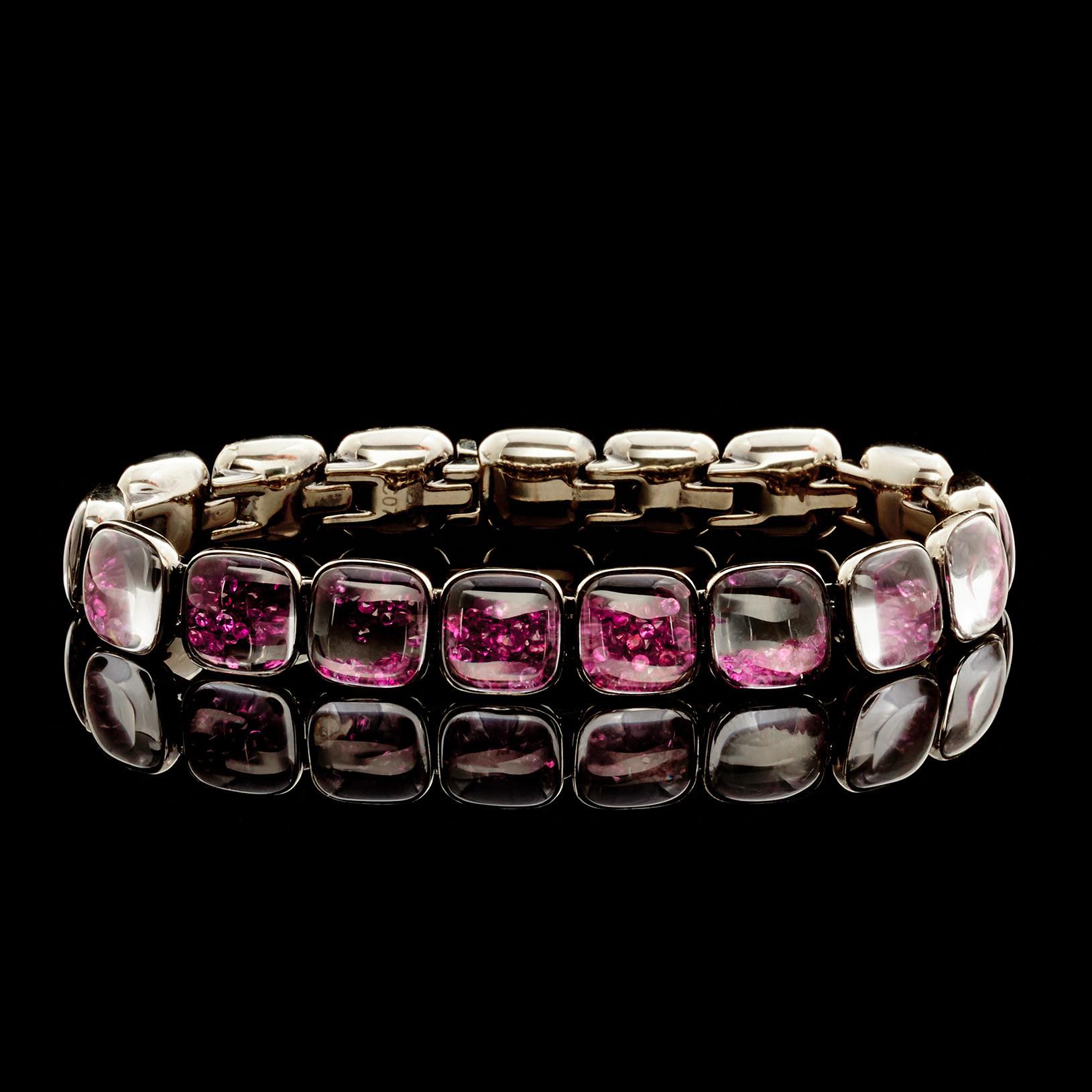 This Modern Design 18Kt White Gold Mattia Cielo Bracelet features 11x11mm square links filled with loose Melee size Rubies totaling 7.35 carats and one link with Black Diamonds totaling 0.70 carats. The length of the bracelet is 7.25 inches and