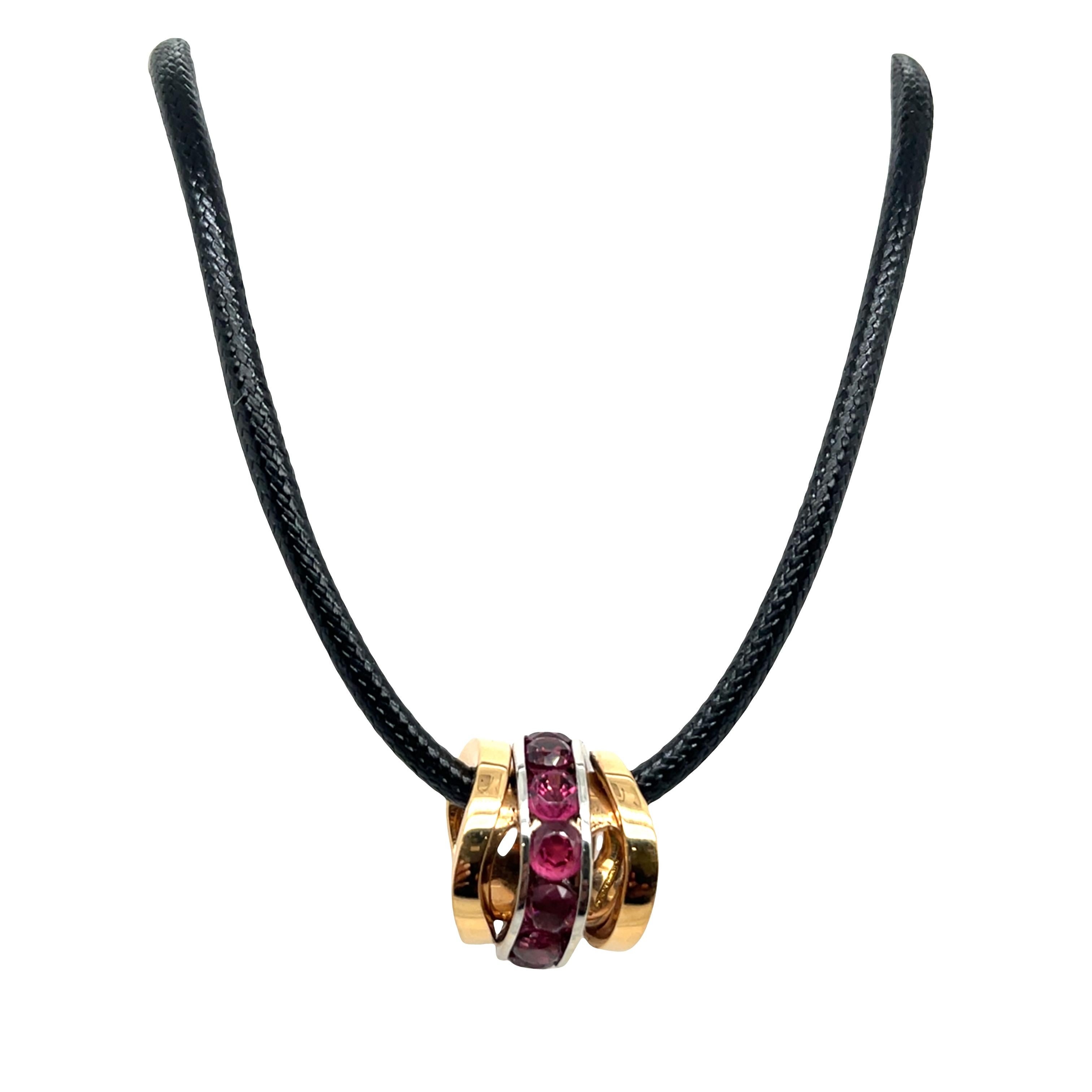 Un'eccezionale creazione di design italiano firmata Mattioli, questo elegante ciondolo ad anello presenta un design a 3 fasce flessibili ornato da una tormalina di forma rotonda incorniciata in oro rosa e bianco 18 ct. La lavorazione artigianale