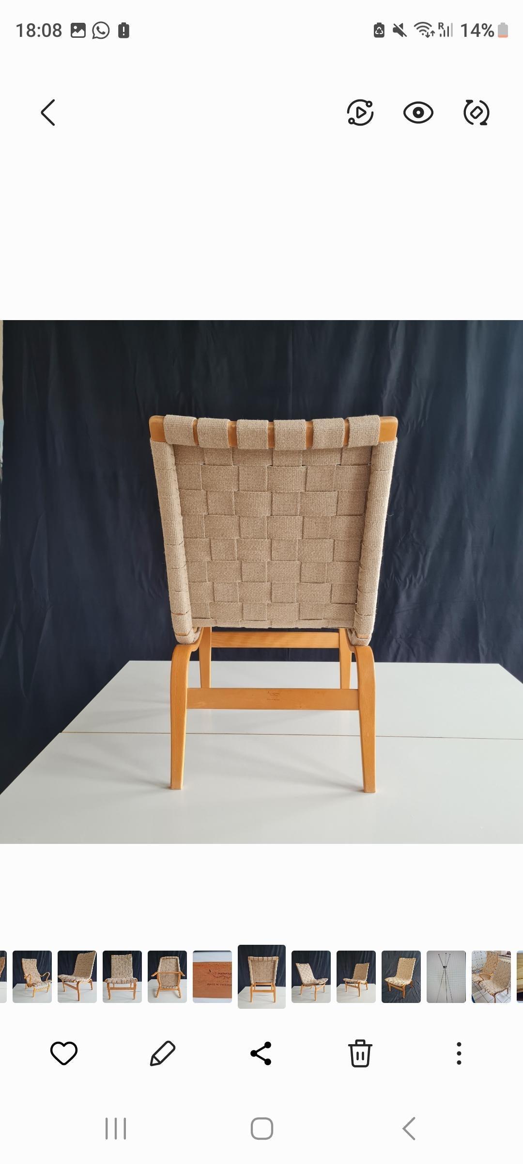 Bruno Mathsson reading chair, originally designed in 1934 in laminated beech bent wood with linen webbing. This later version has original webbing and is in worn original condition. Wood reading tray is missing but hardware is attached to arm rest.