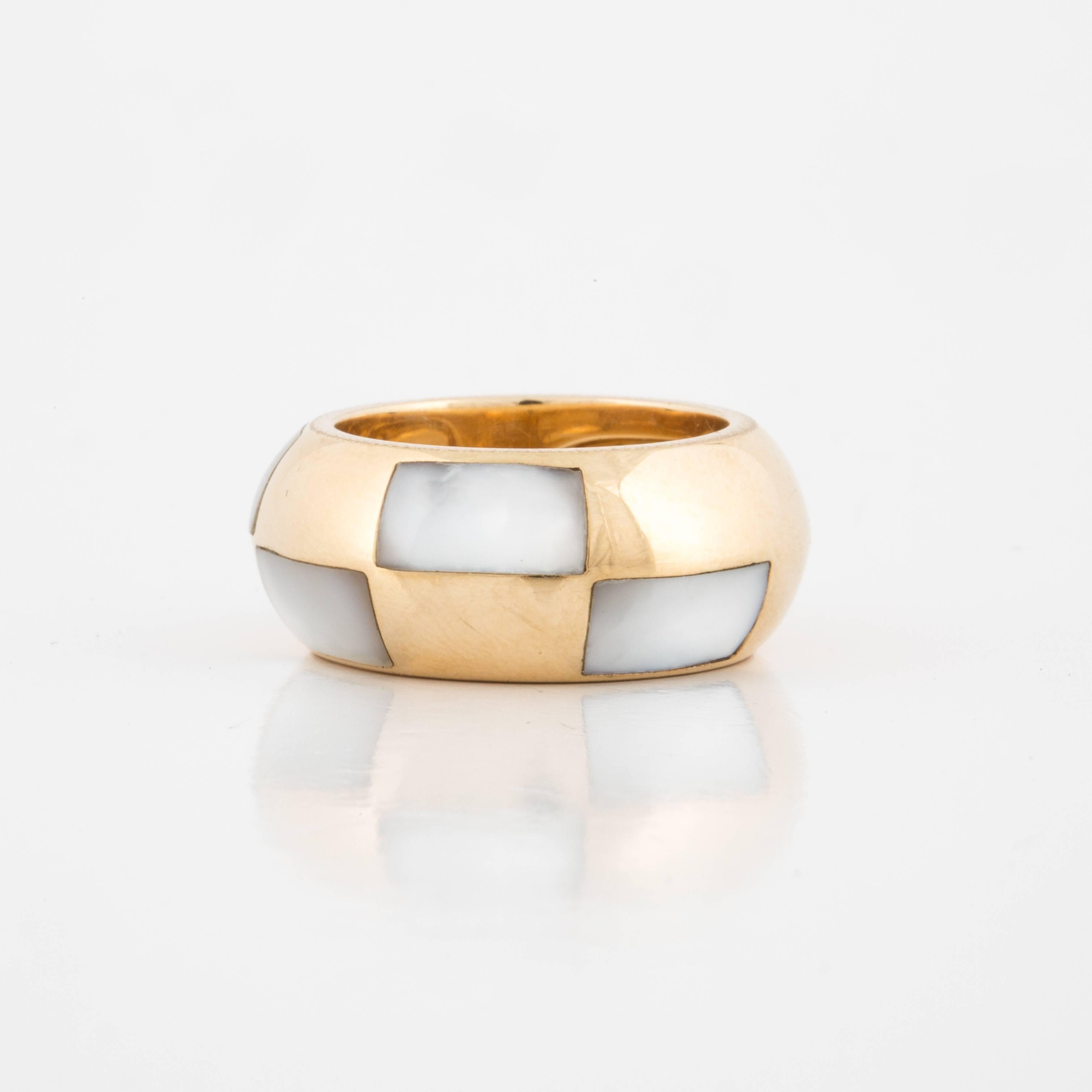 Mauboussin ring composed of 18K yellow gold with five trapezoid shaped mother-of-pearl inlays.   It is marked on the inside, 