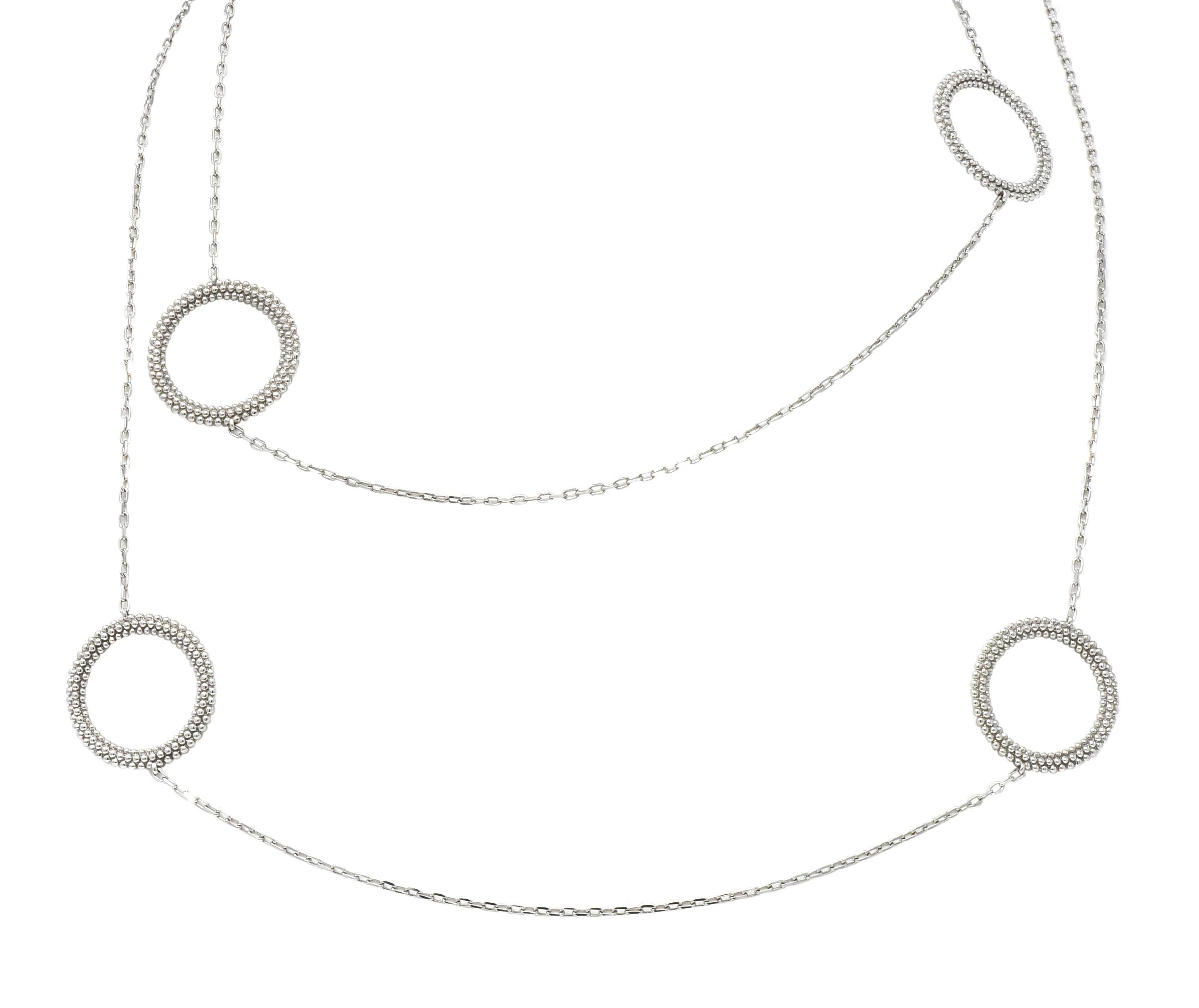 Necklace comprised of delicate elongated link chain with circular stations

Open circle motif stations with a textured, beaded finish

Completed by bar and toggle clasp

Fully signed Mauboussin, numbered, with French assay marks

Stamped 750 for 18