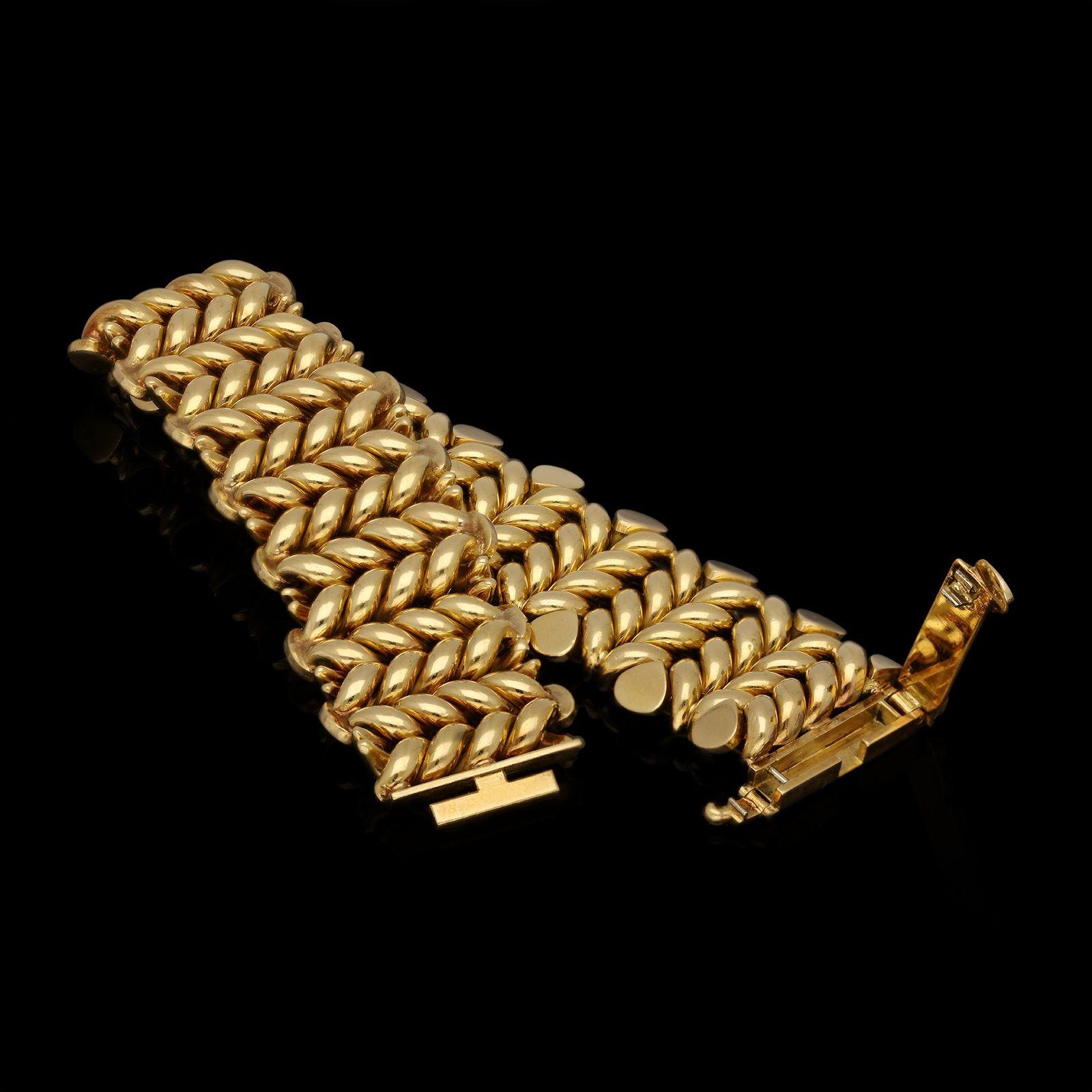 A wonderfully stylish vintage French gold bracelet by Mauboussin c.1970s, of twisted uniform bar link design, edged by rows of angled pear-shape motifs, all in highly polished 18ct yellow gold to a concealed clasp. This a beautifully supple and