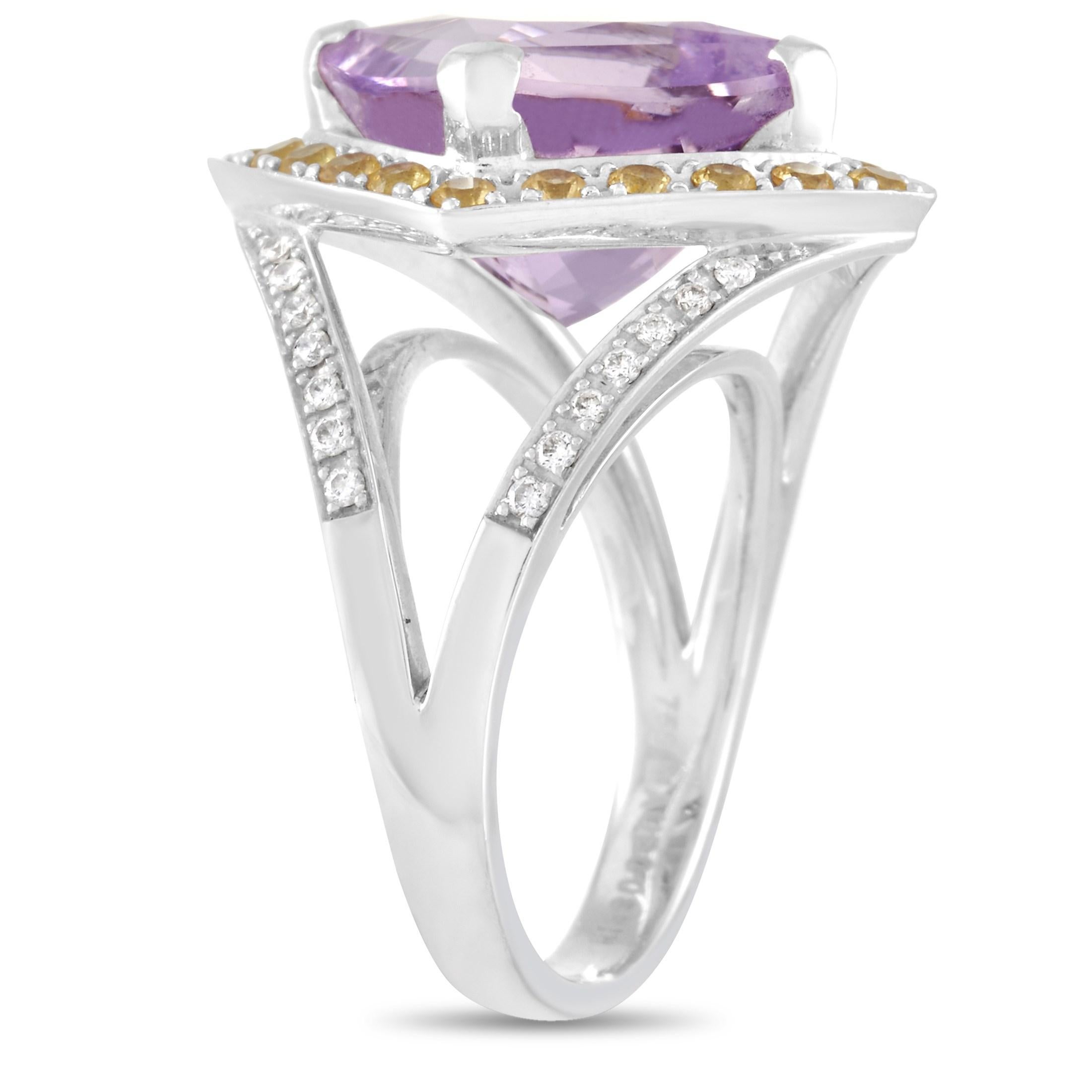 This Mauboussin 18K White Gold Amethyst, Citrine, and Diamond Ring is a stunning piece that oozes glamour and style. The band is made with 18K white gold and set with numerous round cut diamonds. At the center of the ring, round cut citrines for a