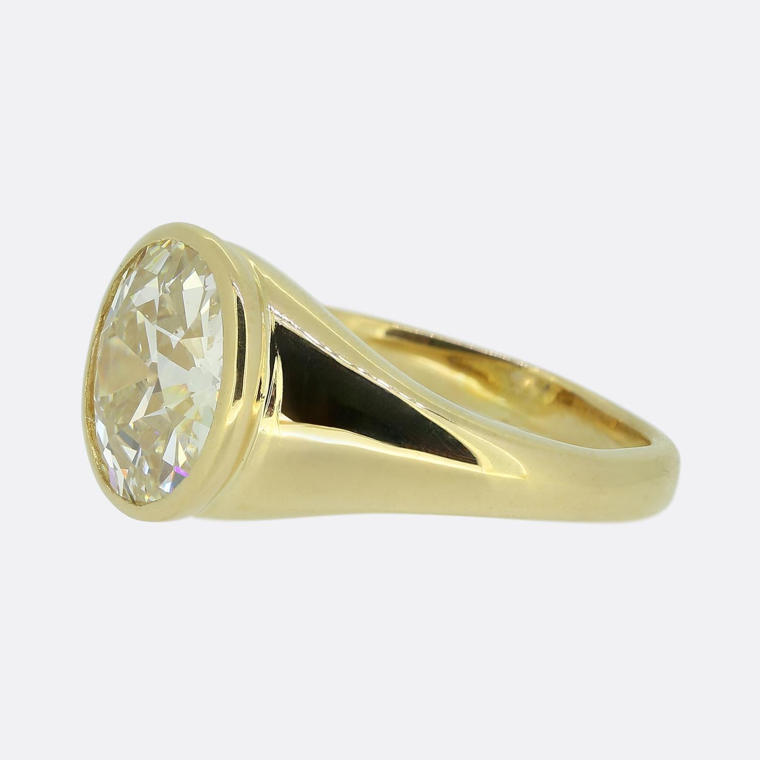 Here we have a remarkable single stone diamond ring by Mauboussin. This vintage piece showcases a prominent 4.01 cart round faceted old European cut diamond, exuding a captivating white hue. This clean diamond is secured in a sleek bezel setting,
