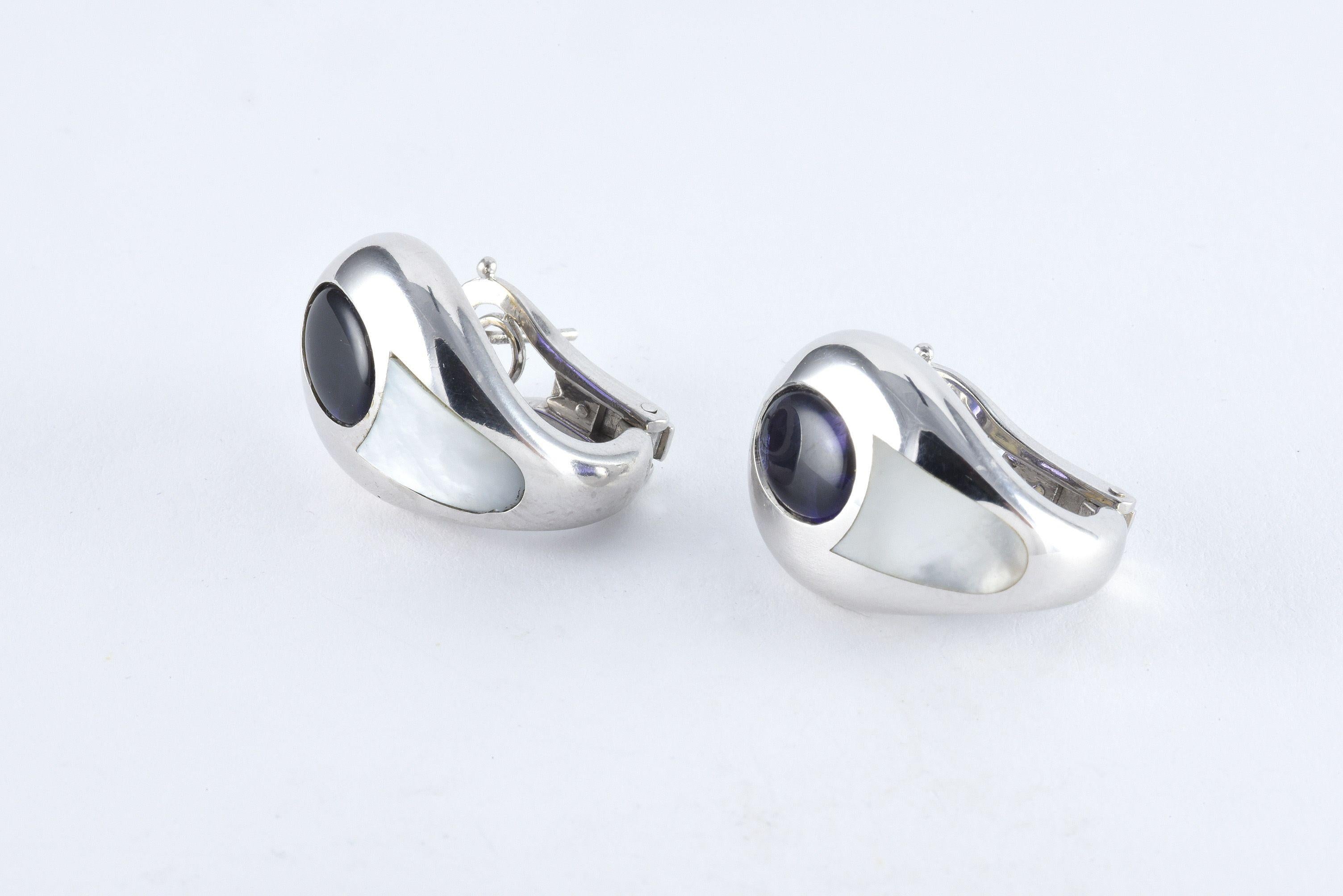 These vintage Mauboussin earrings handcrafted in 18kt white gold each feature an oval-shaped Iolite and inlaid mother of pearl and secured with an omega back. 
