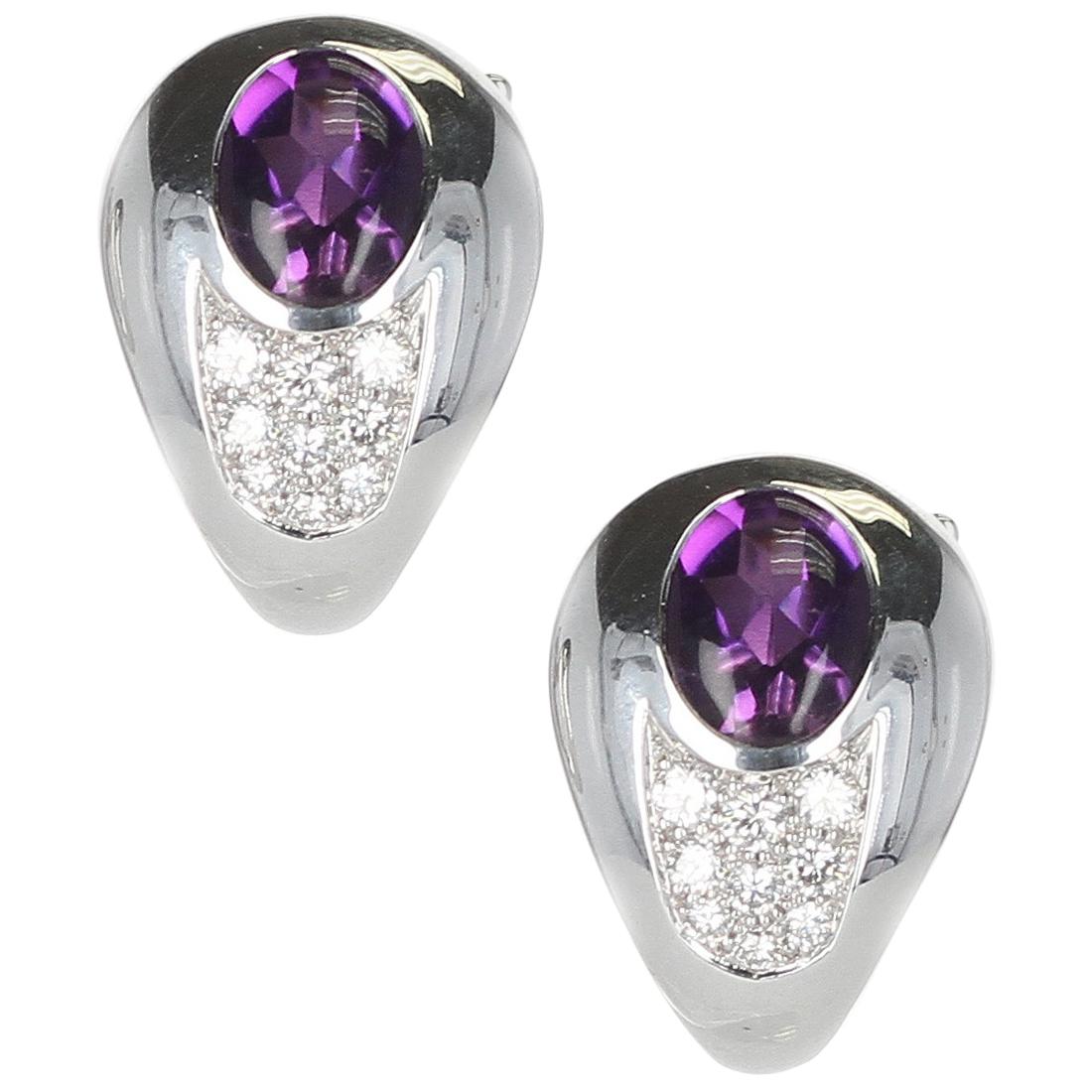 A pair of Mauboussin Amethyst and Diamond Earrings made in 18 Karat Yellow Gold. The total weight of the earrings is 17.35 grams. The amethyst weighs 2.20 carats and the diamonds weigh 0.42 carats. The earrings are clip-ons.  


