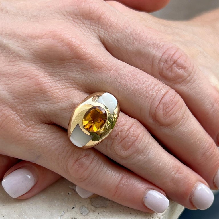 Mauboussin dome cocktail ring crafted in 18 karat yellow gold. The ring features an oval citrine gemstone and inlay mother of pearl. The dome ring measures 15mm in width and is size 5.5. Signed, hallmarked, and numbered. 