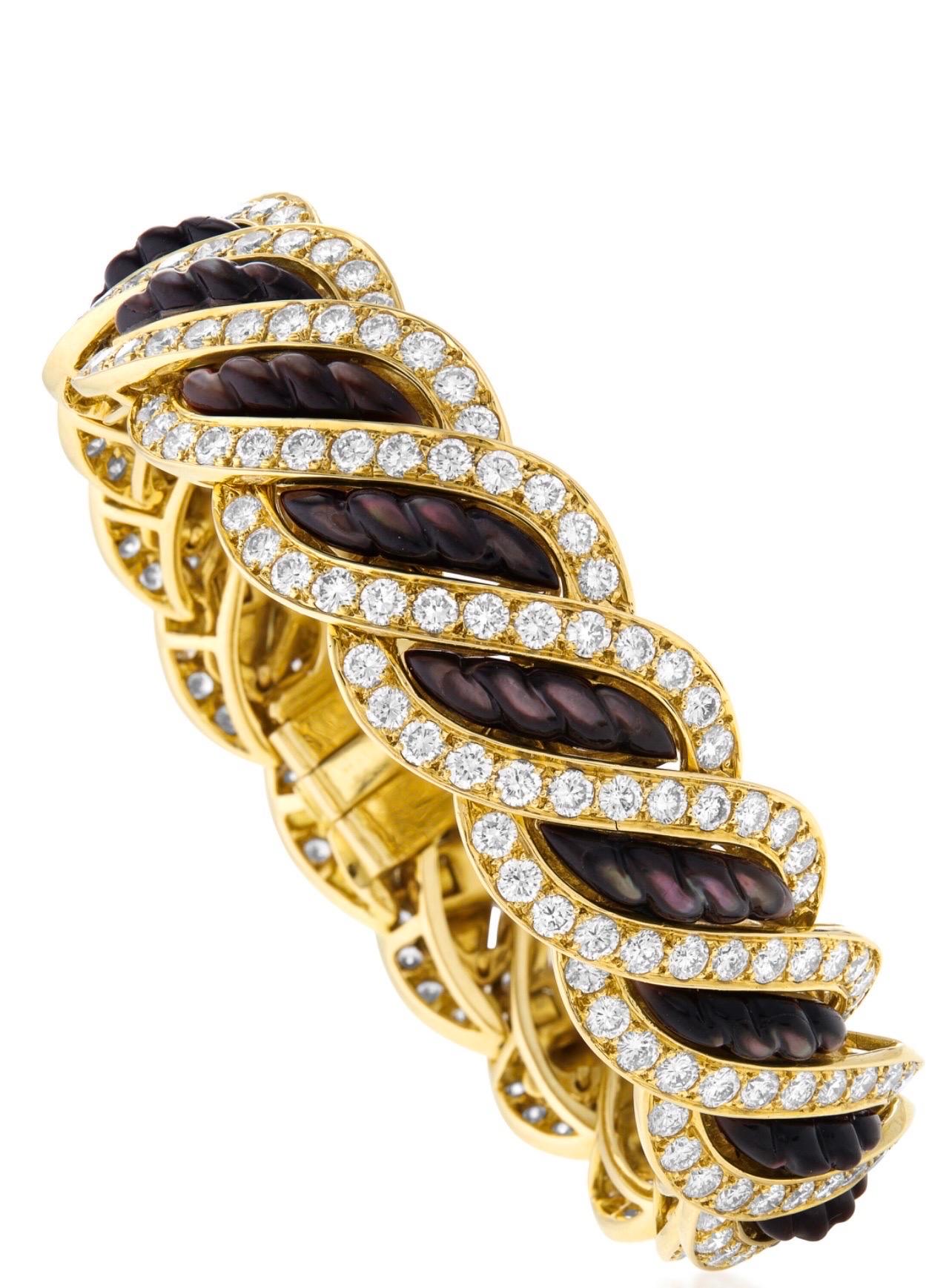 Bold and stunningly fashionable, this remarkable bracelet is designed by Mauboussin and boasts incredibly offbeat, eye-catching appearance. The bracelet is made of radiant 18K yellow gold and it is embellished with black mother of pearl and