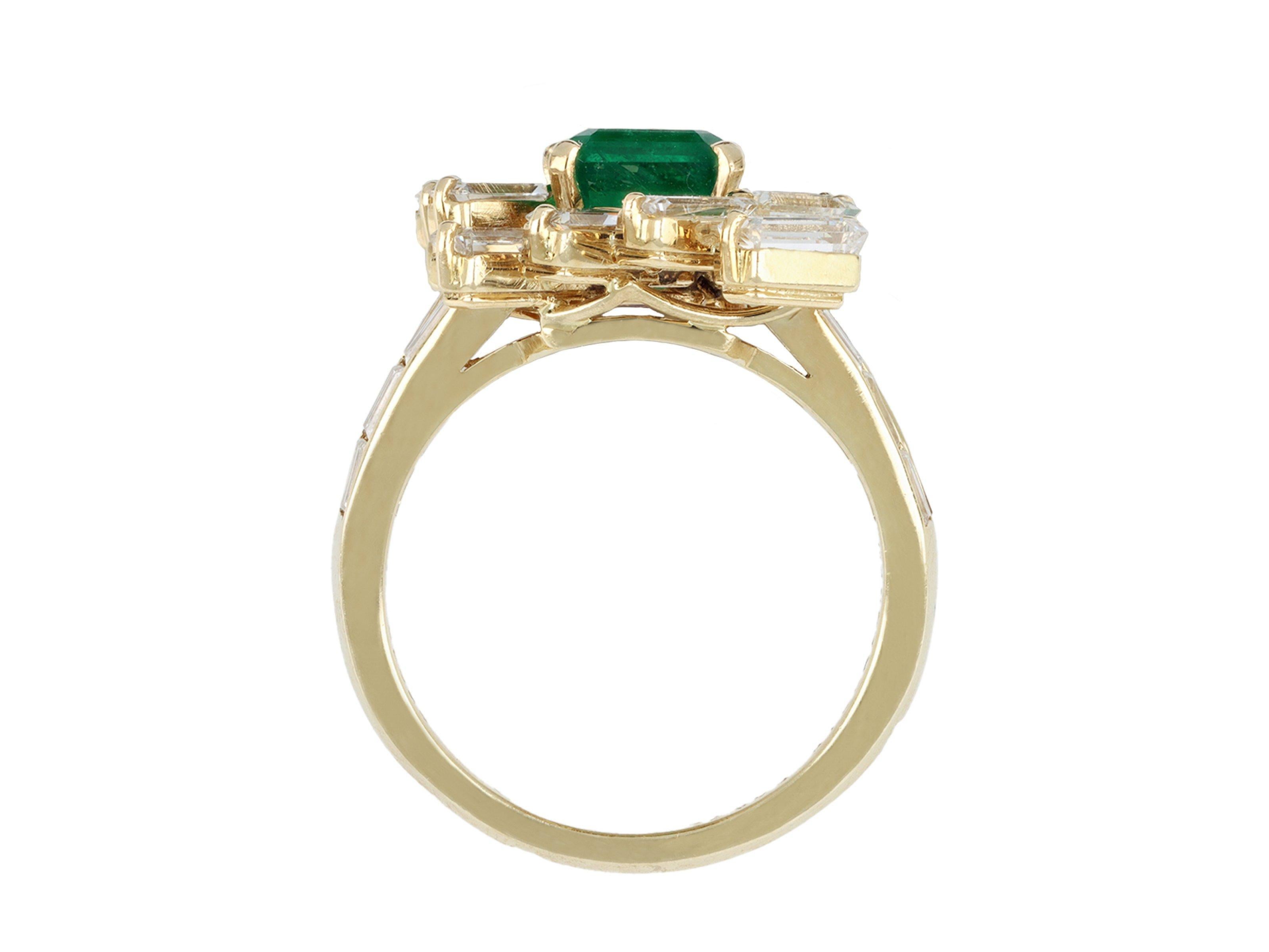 Mauboussin emerald and diamond cluster ring. Set with one octagonal emerald-cut natural Zambian emerald in an open back claw setting with an approximate weight of 2.40 carats, surrounded fourteen rectangular and tapered baguette cut diamonds in open