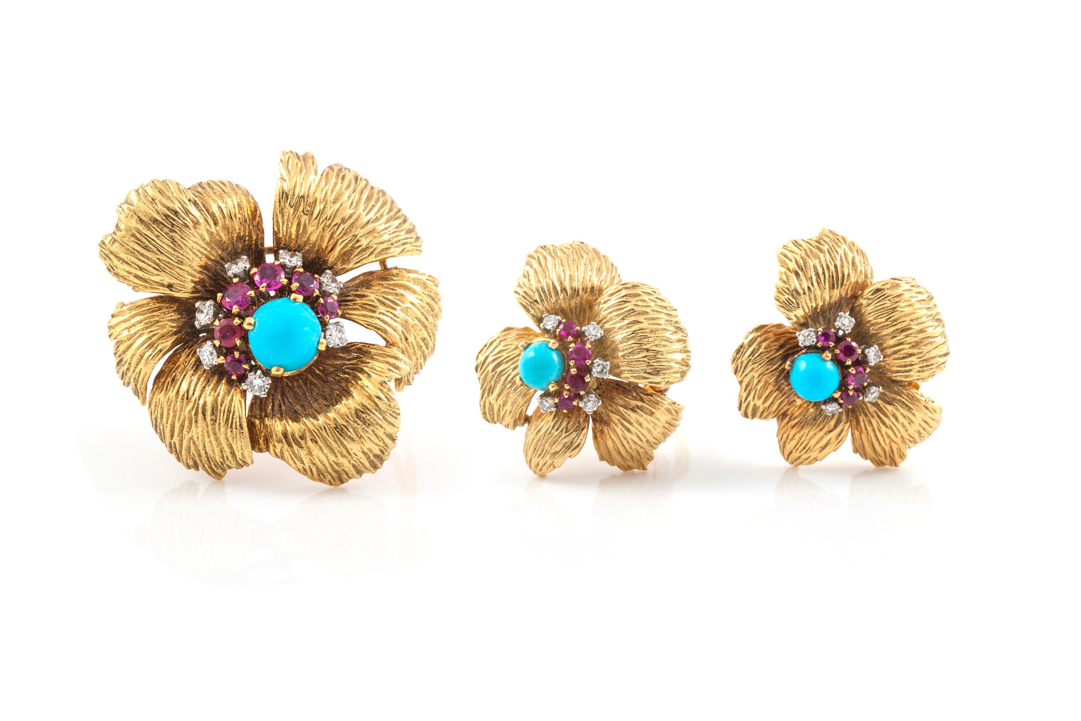 Mauboussin 18K Flower earrings accompanied by 5 small diamonds, 4 rubies and a hint of turquosie at the center.  
Mauboussin 18K Flower Brooch accompanied by 7 small diamonds, 6 rubies and a hint of turquosie at the center.