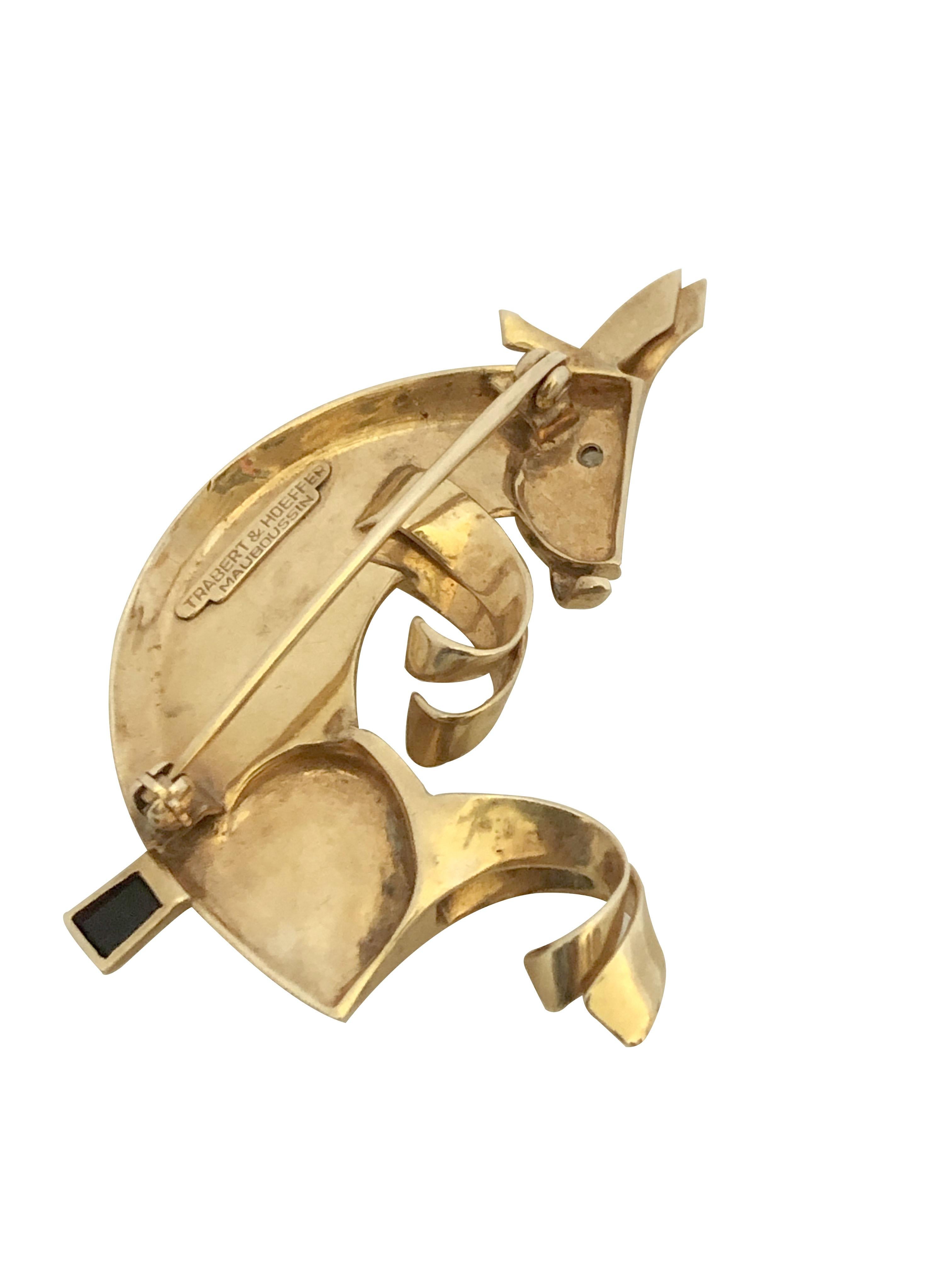 Circa 1940s Mauboussin for Trabert & Hoeffer Very Whimsical and Retro Stylized 14K yellow Gold Donkey Brooch, measuring 2 inches in length X 1 1/2 inches. Having a Diamond Eye and a faceted Onyx Tail. 