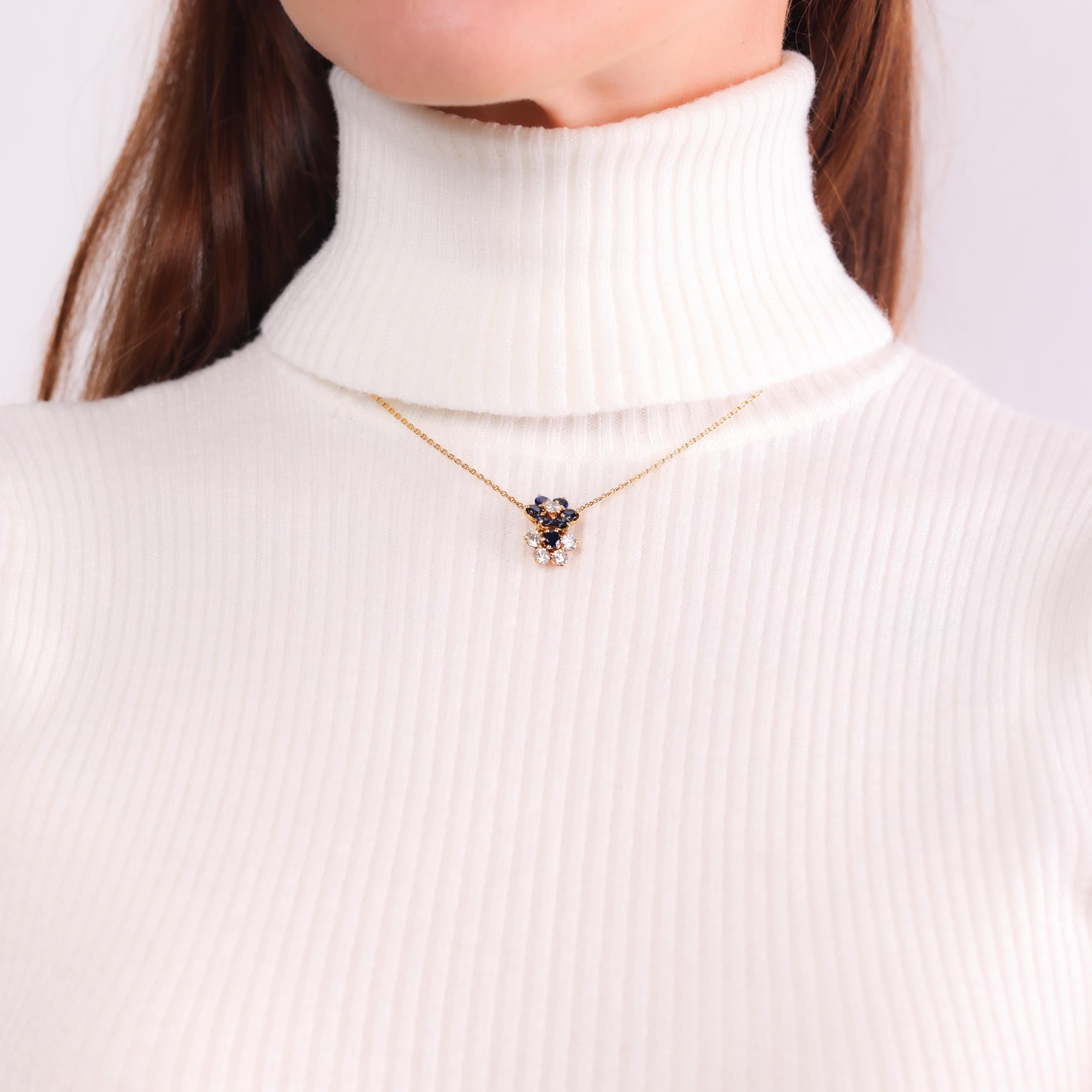This vintage Mauboussin 18k yellow gold flower necklace sparkles with vibrant blue sapphires and dazzling diamonds, showcasing exceptional French craftsmanship and timeless elegance from the 1990s.

Brand: Mauboussin Paris
Center stone: 7 round