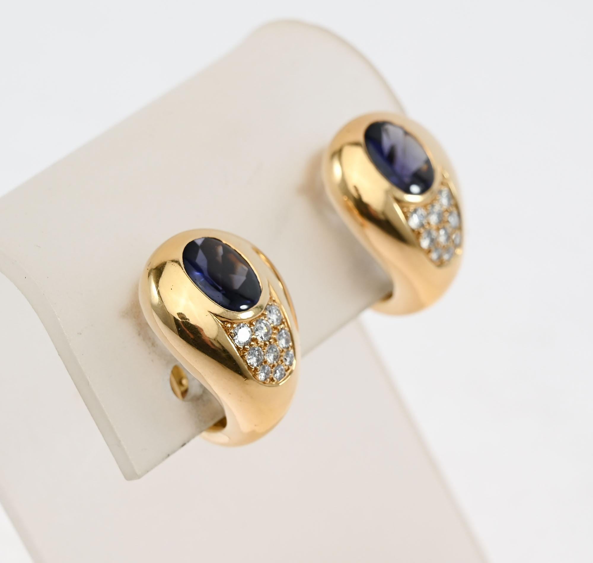 Mauboussin pear shaped earrings with a central iolite stone with nine diamonds below. The iolite is a rich shade of blue. The earrings are timeless in design. They work well for day or night. Backs are clips that can be converted to posts. The