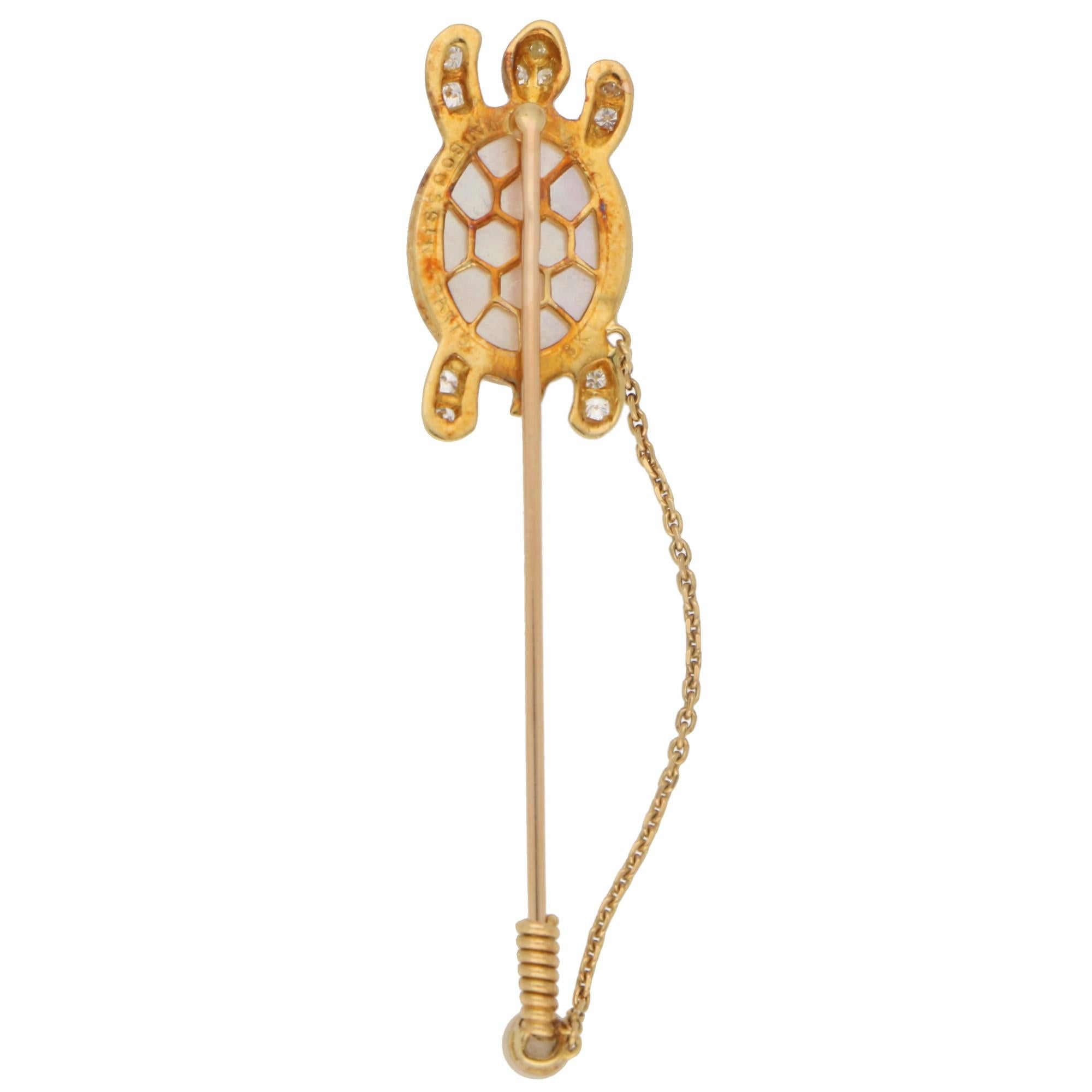 A lovely little moonstone and diamond stick pin set in 18k yellow gold, signed Mauboussin. 

The stick pink depicts a walking turtle and is composed of a large carved piece of lustrous moonstone. This moonstone forms the shell of the turtle and is