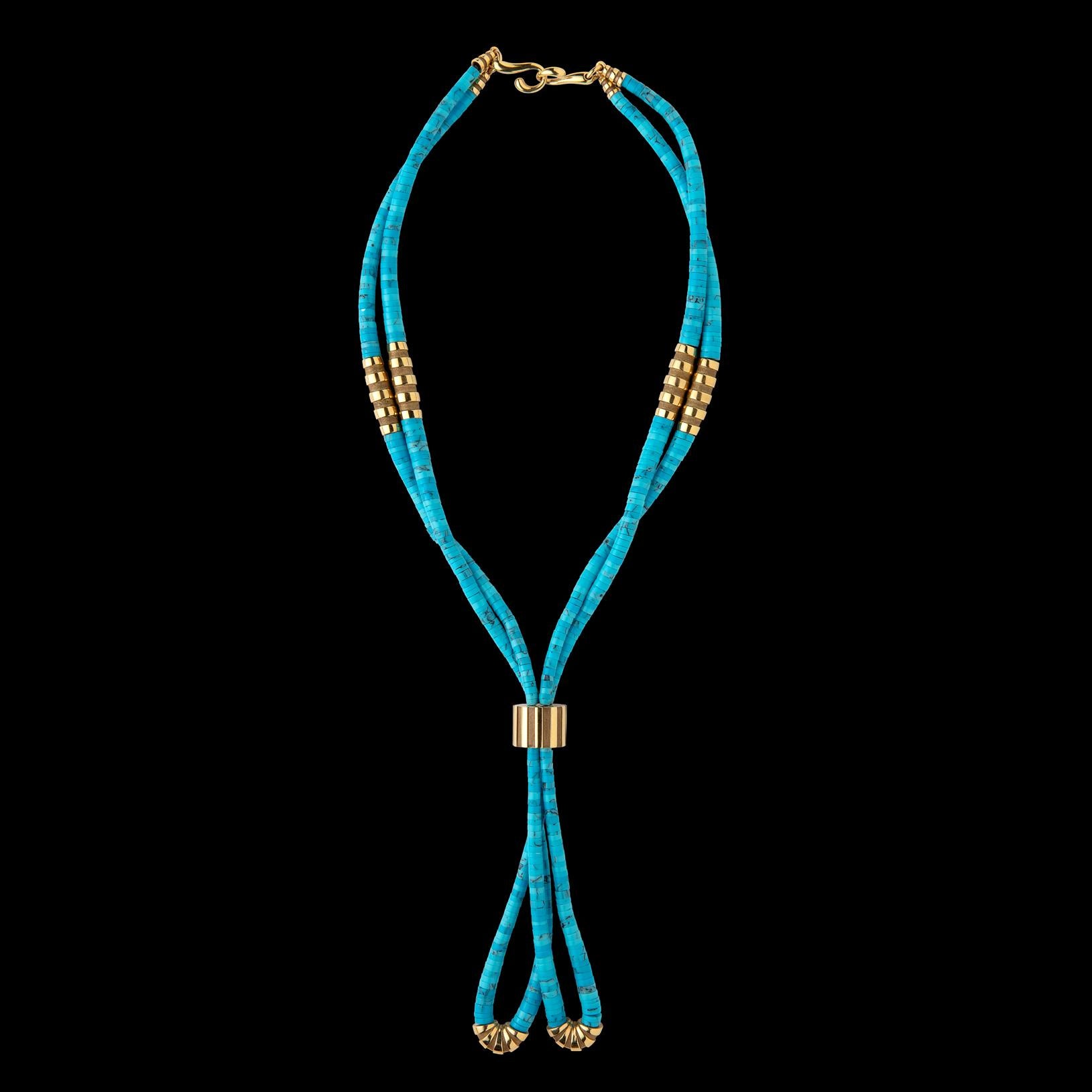A unique piece by famed French maker Mauboussin, the 18k gold 'Nadja' necklace is designed as two strands of turquoise beads, accented by fluted gold sections of polished/satin finish, and centered by a large gold bead of similar design. The length