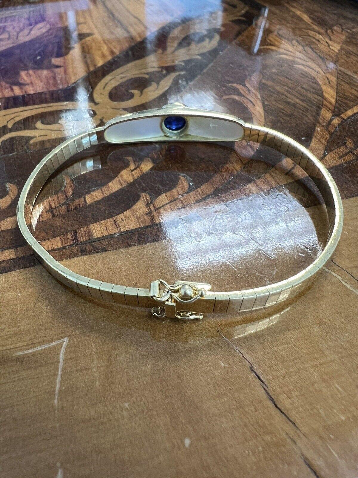 Mauboussin Paris 18k Yellow Gold, Mother of Pearl & Sapphire Omega Bracelet Vintage Circa 1980s

Here is your chance to purchase a beautiful and highly collectible designer bracelet.   

THIS BEAUTIFUL BRACELET IS MARKED / STAMPED / SIGNED =