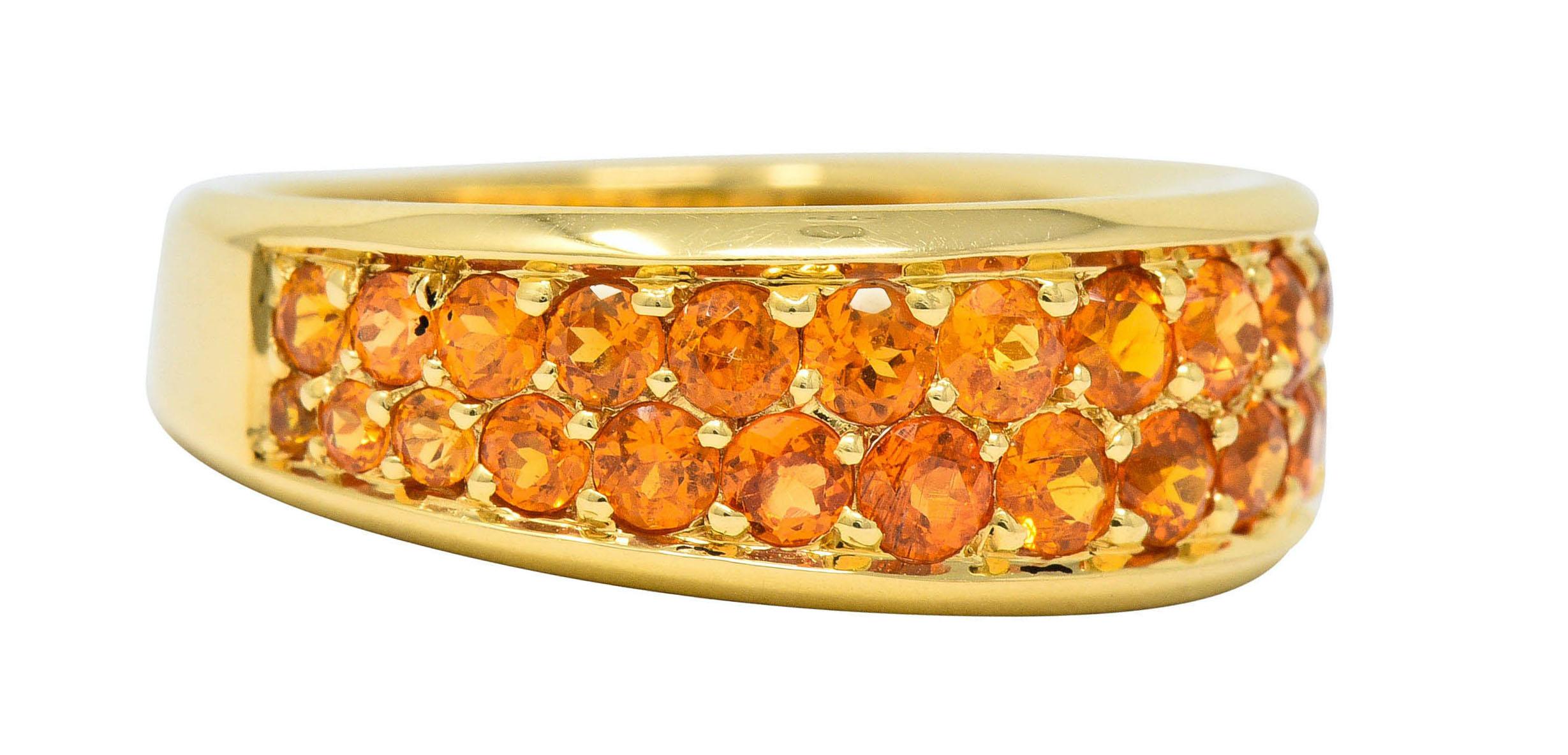 Wide band ring pavé set to front with orange sapphires, graduating in size

Very well-matched vibrant orange in color and weigh approximately 1.95 carat total

Numbered, fully signed Mauboussin Paris, and with maker's mark

Stamped 750 and with
