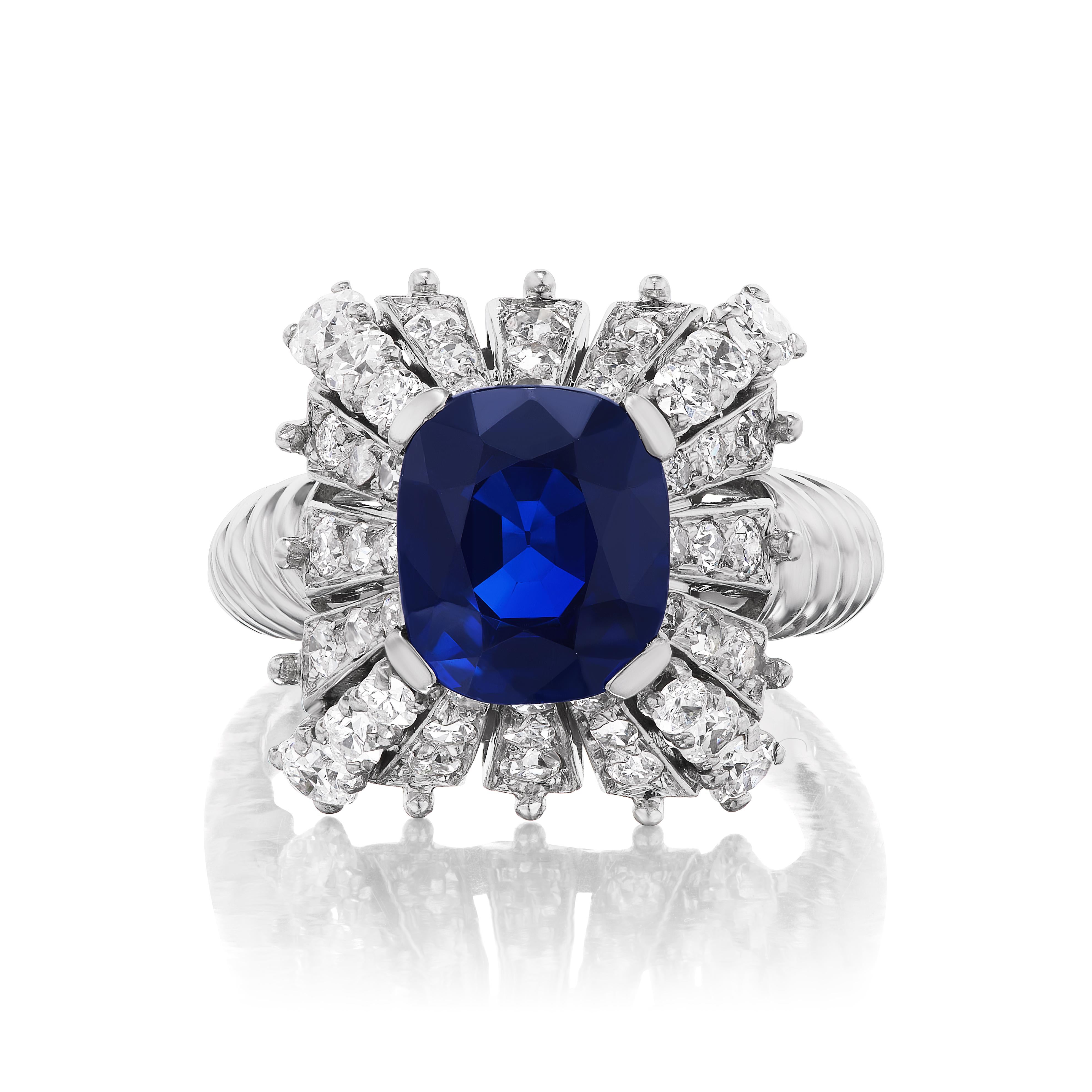 This exquisitely designed Art Deco period ring features a 3.47ct cushion-cut unheated Thai sapphire of excellent color and clarity. The stone is superb and is further accentuated by 48 single cut diamonds weighing approximately 2.00 carats laid out